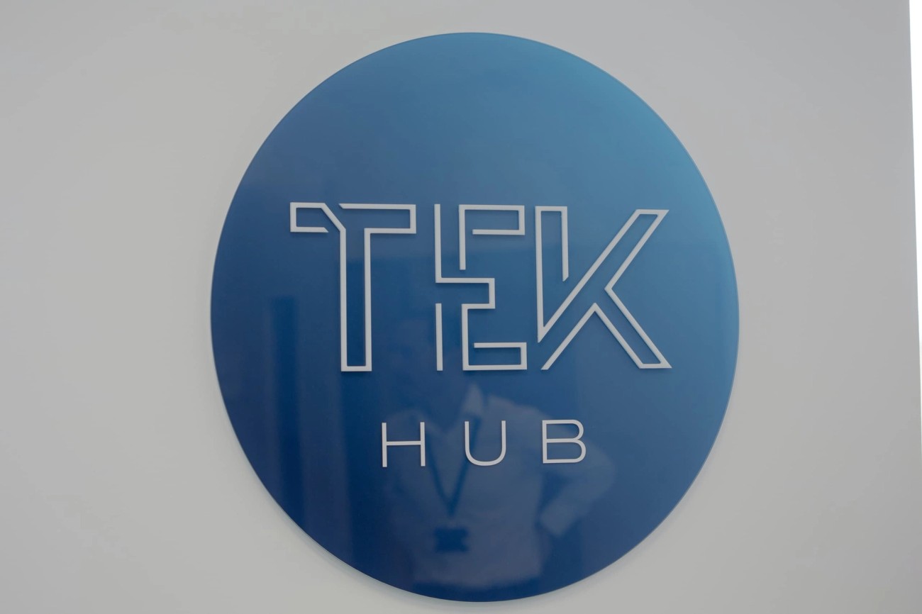 Round TEK-HUB logo on wall