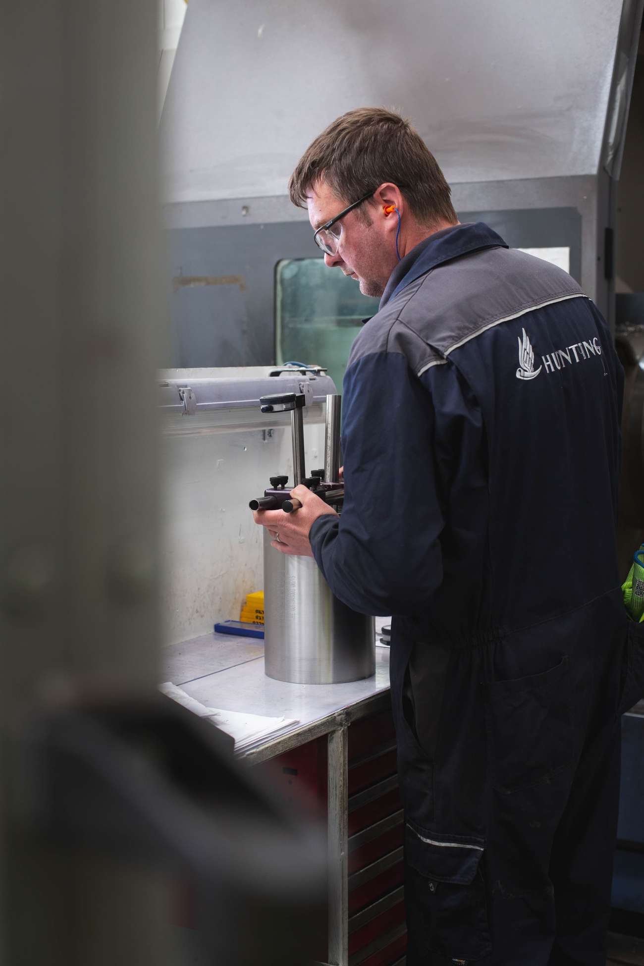 Person in Hunting overall testing a tubular device