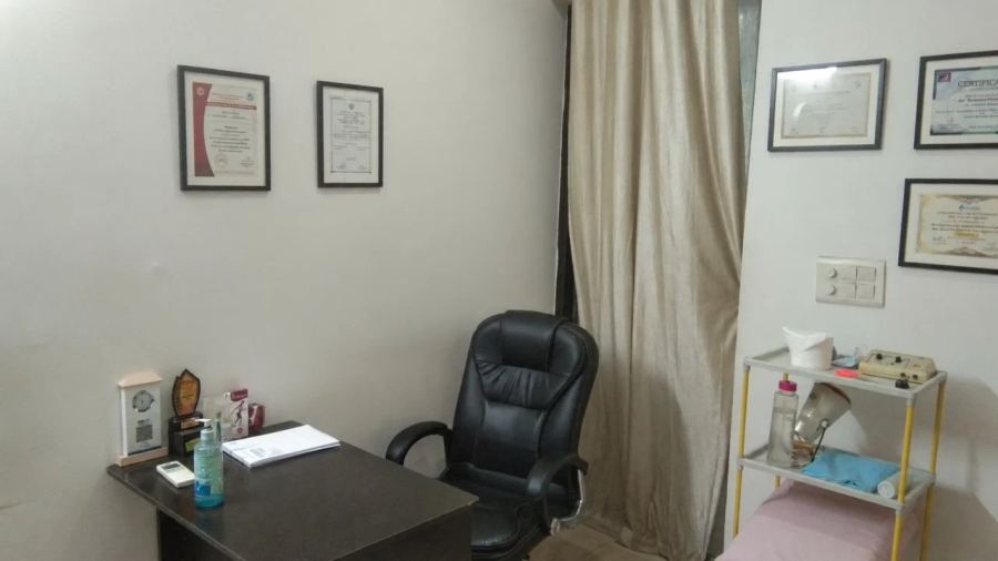 Consultation desk and qualifications displayed in Dr. Chauhan’s clinic
