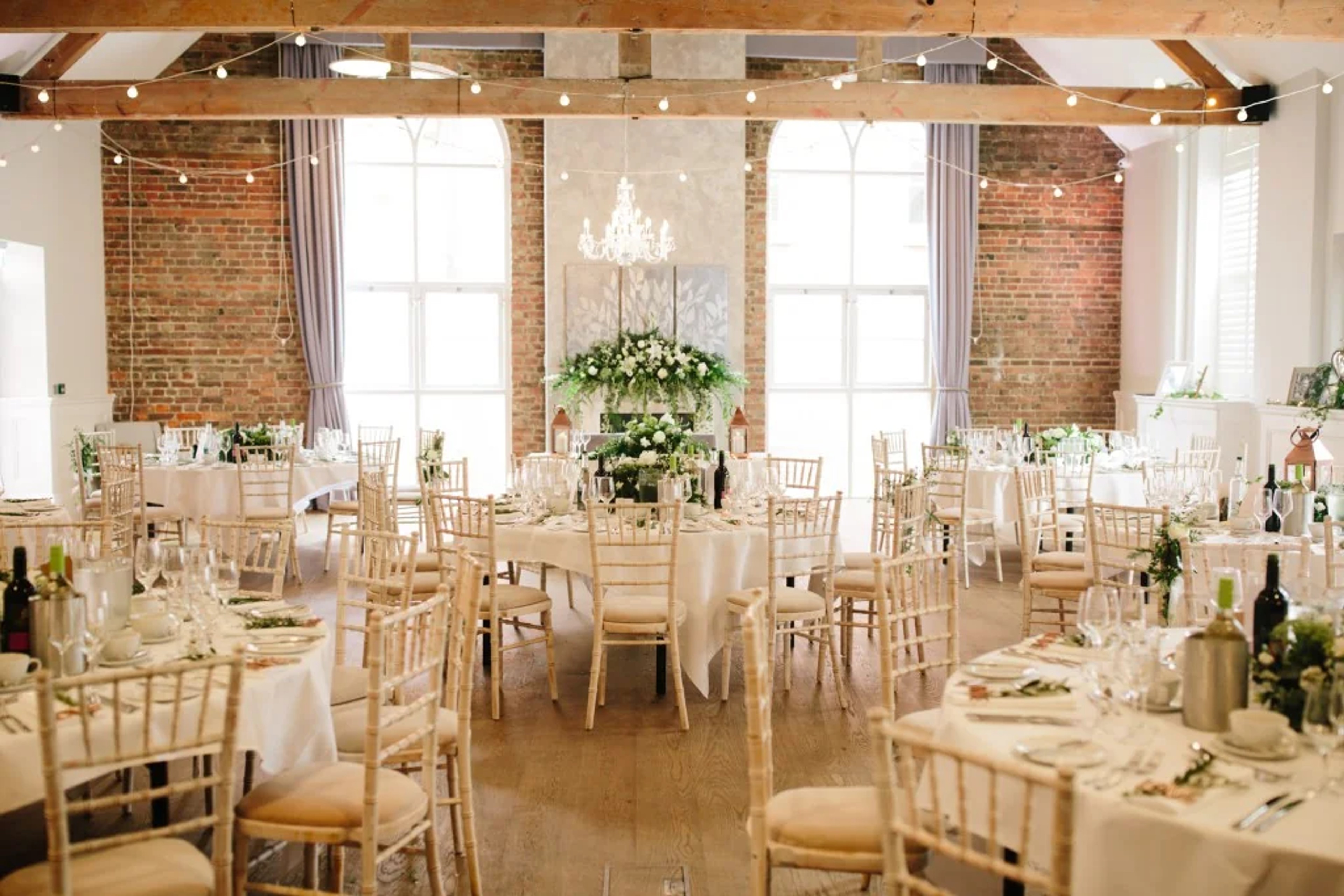 Wedding reception at One Warwick Park with exposed beams and fairy lights