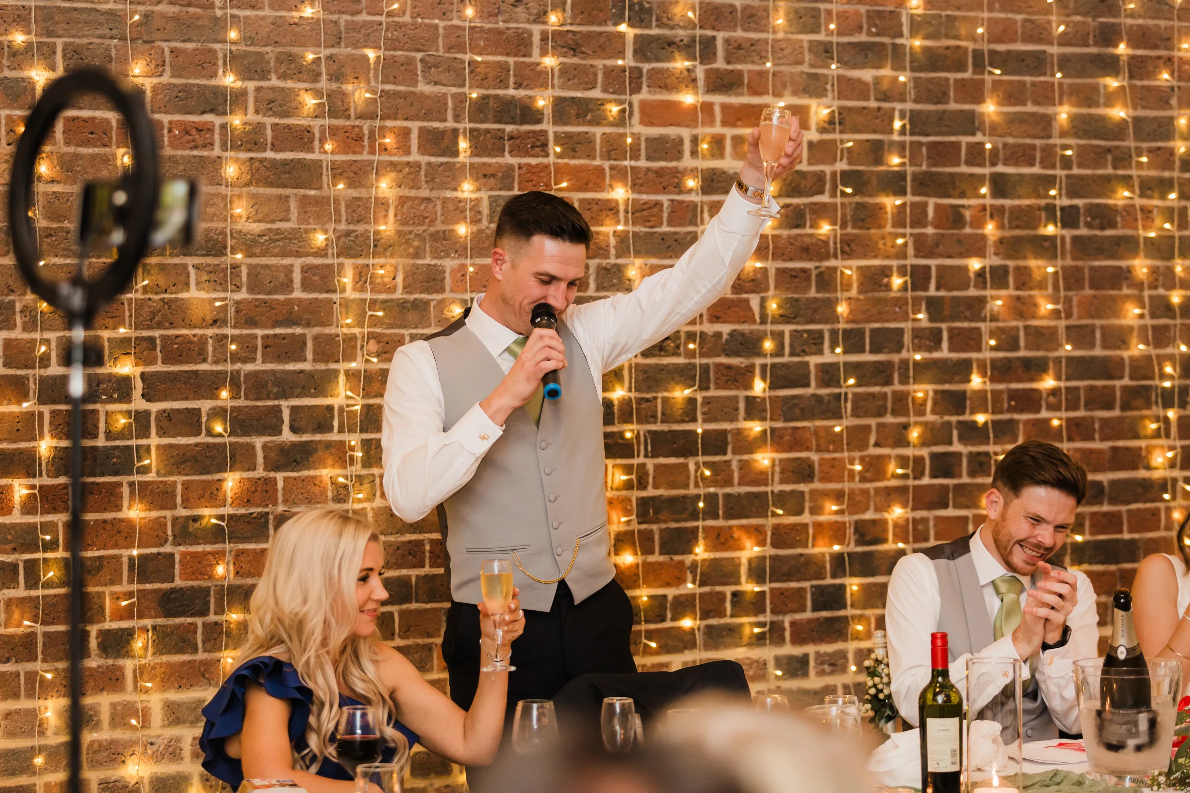 Wedding toast with raised glasses during speeches