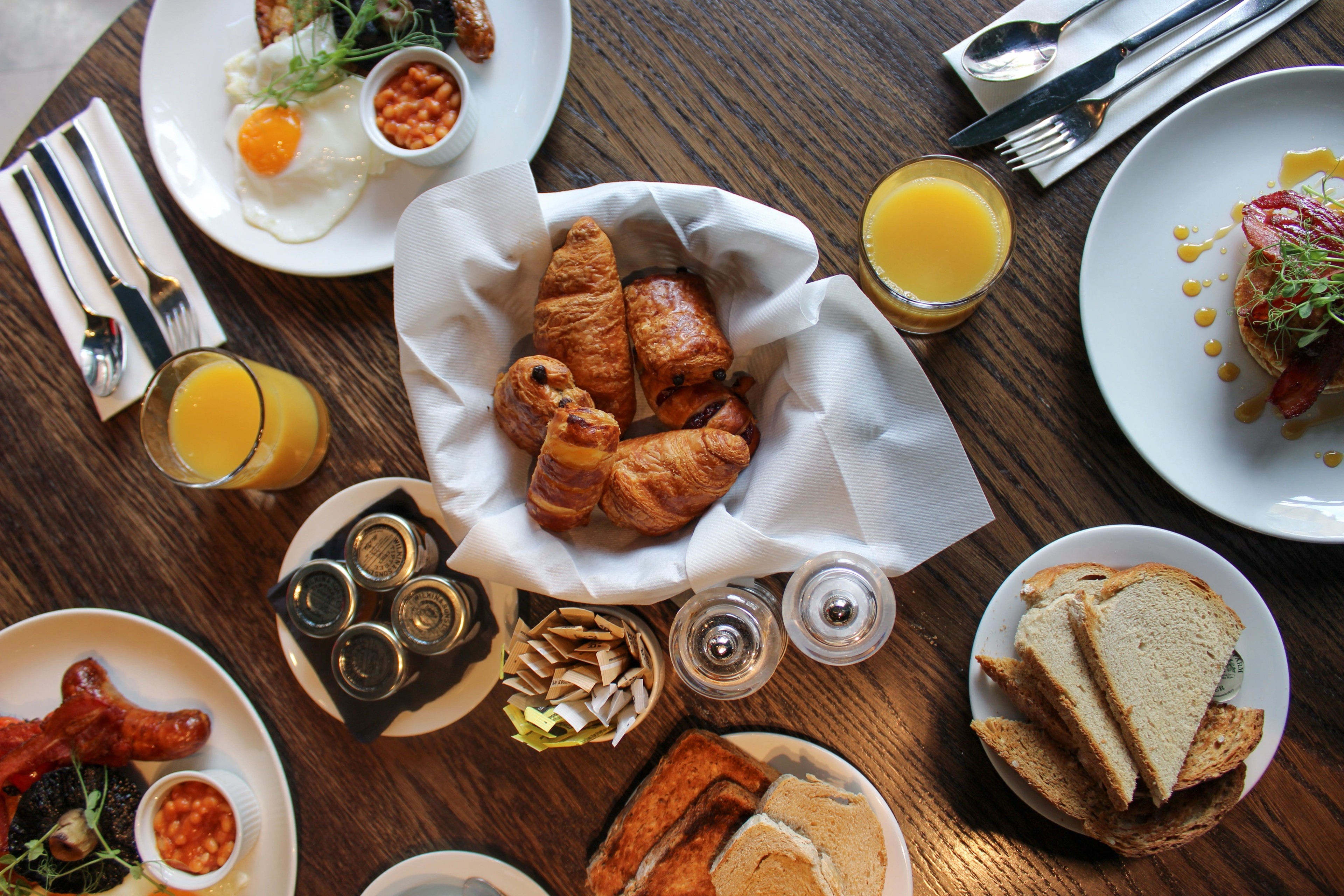 Breakfast spread with croissants and orange juice at The Brasserie