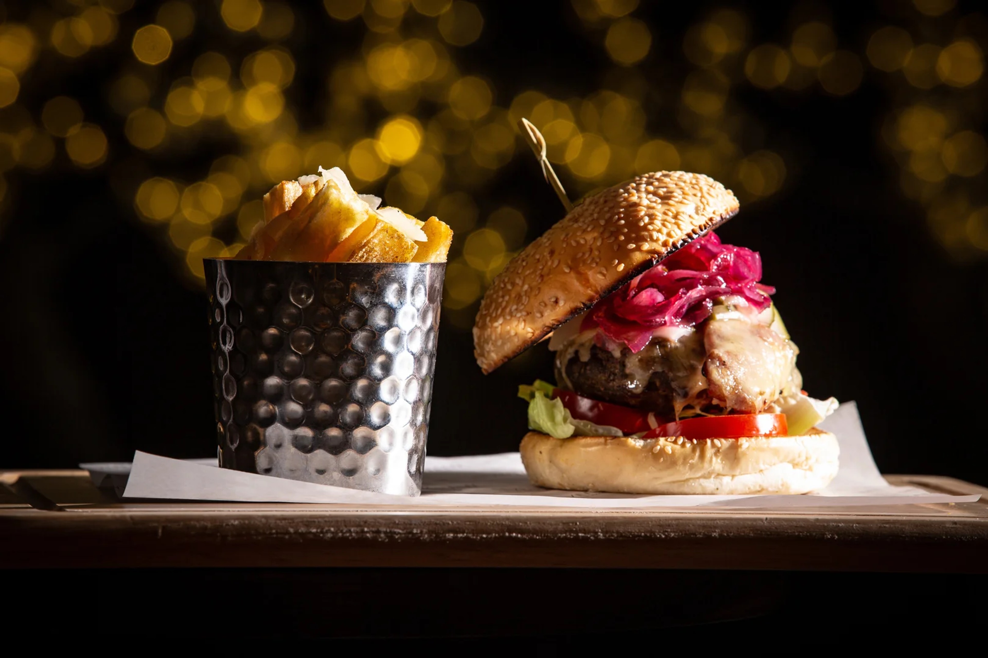 Gourmet burger with pickled onions and hand-cut chips