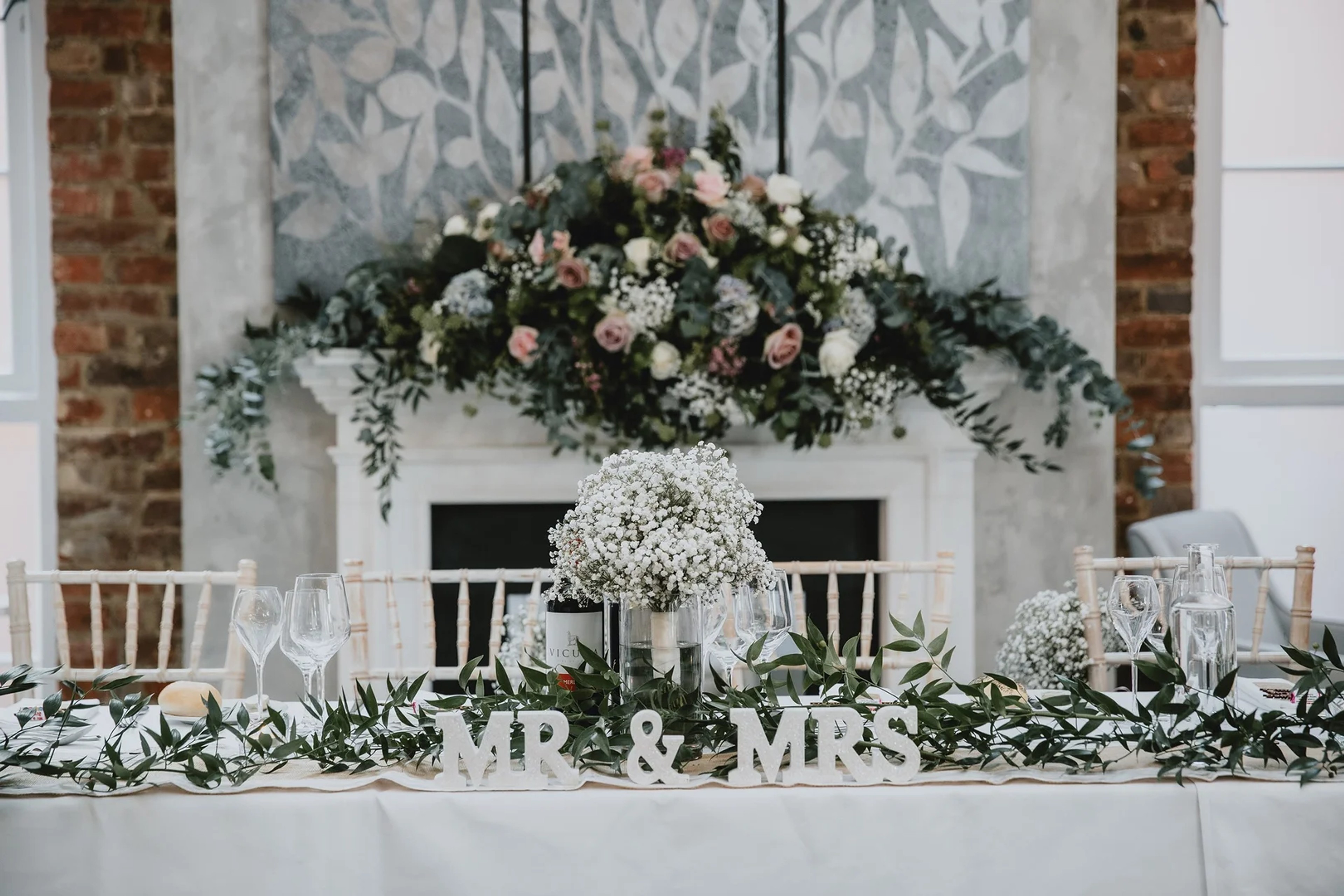 Elegant top table with Mr & Mrs sign and floral arrangements