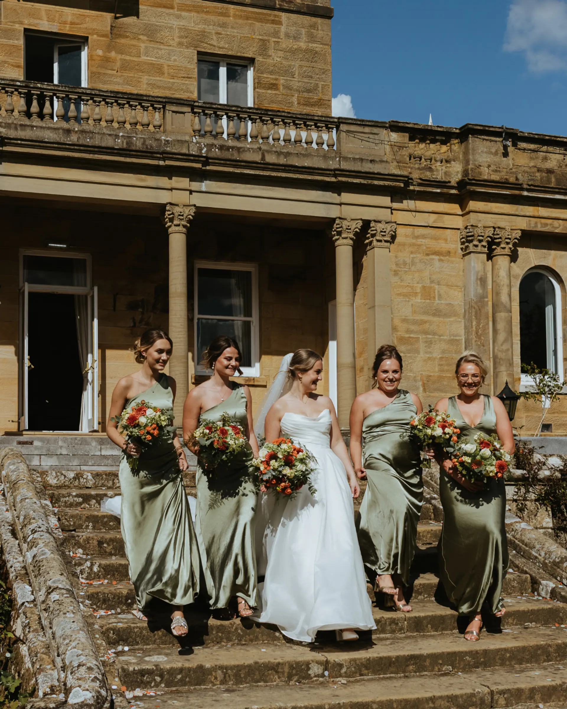 Bride with bridesmaids on the steps of Salomons Estate
