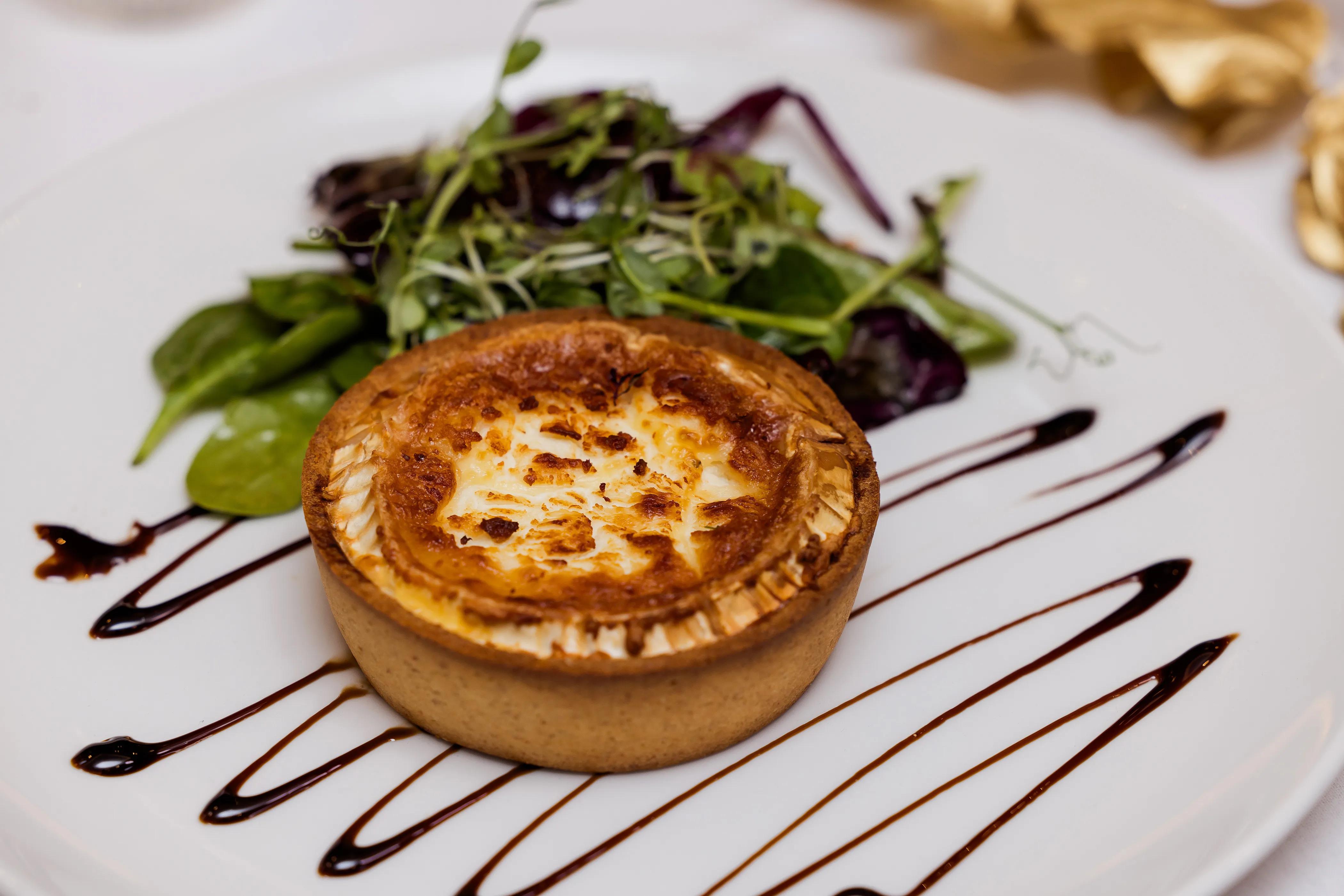 Golden goats cheese tart with fresh salad leaves at Salomons Estate