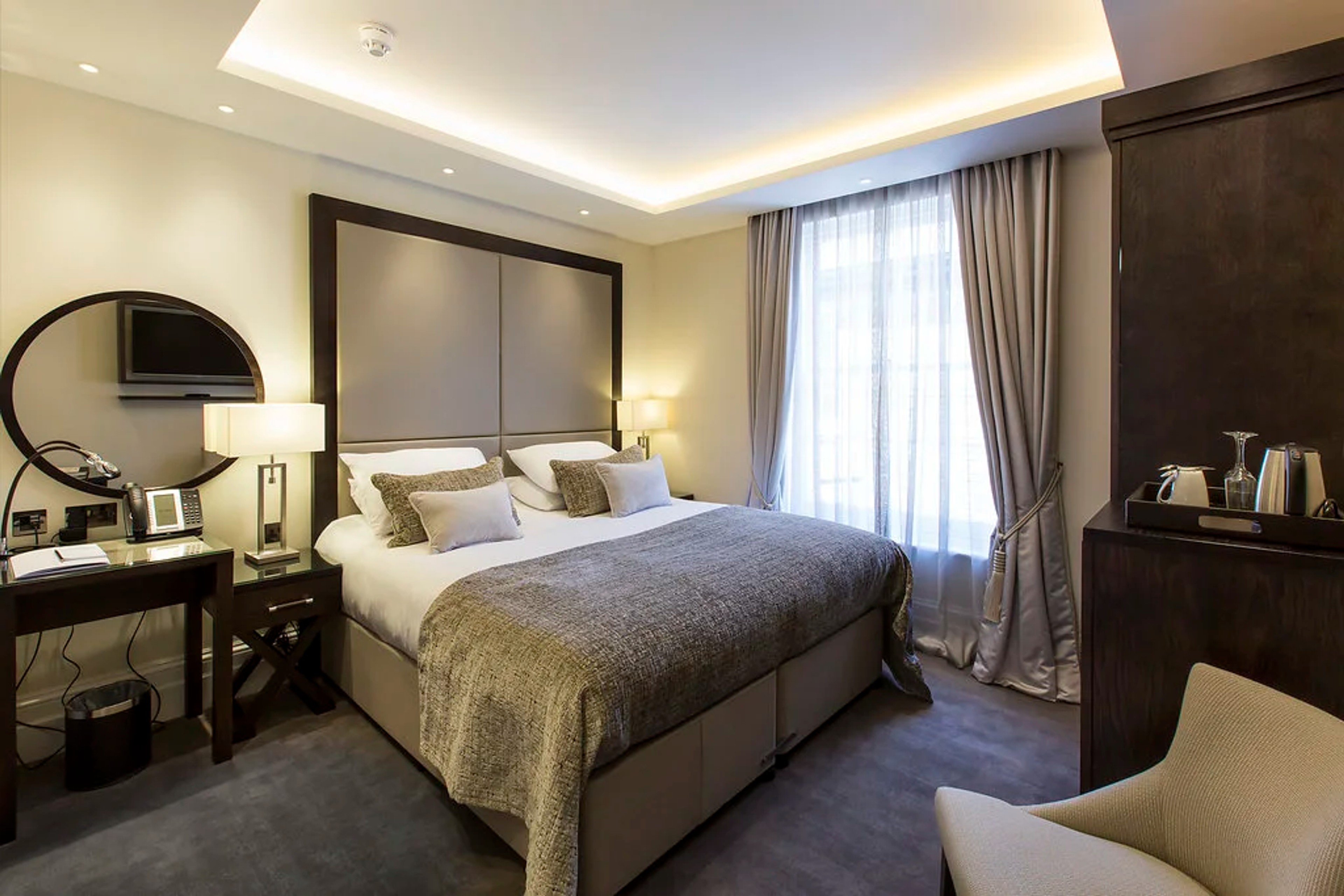 Modern Club Room with cove lighting, desk and coffee facilities