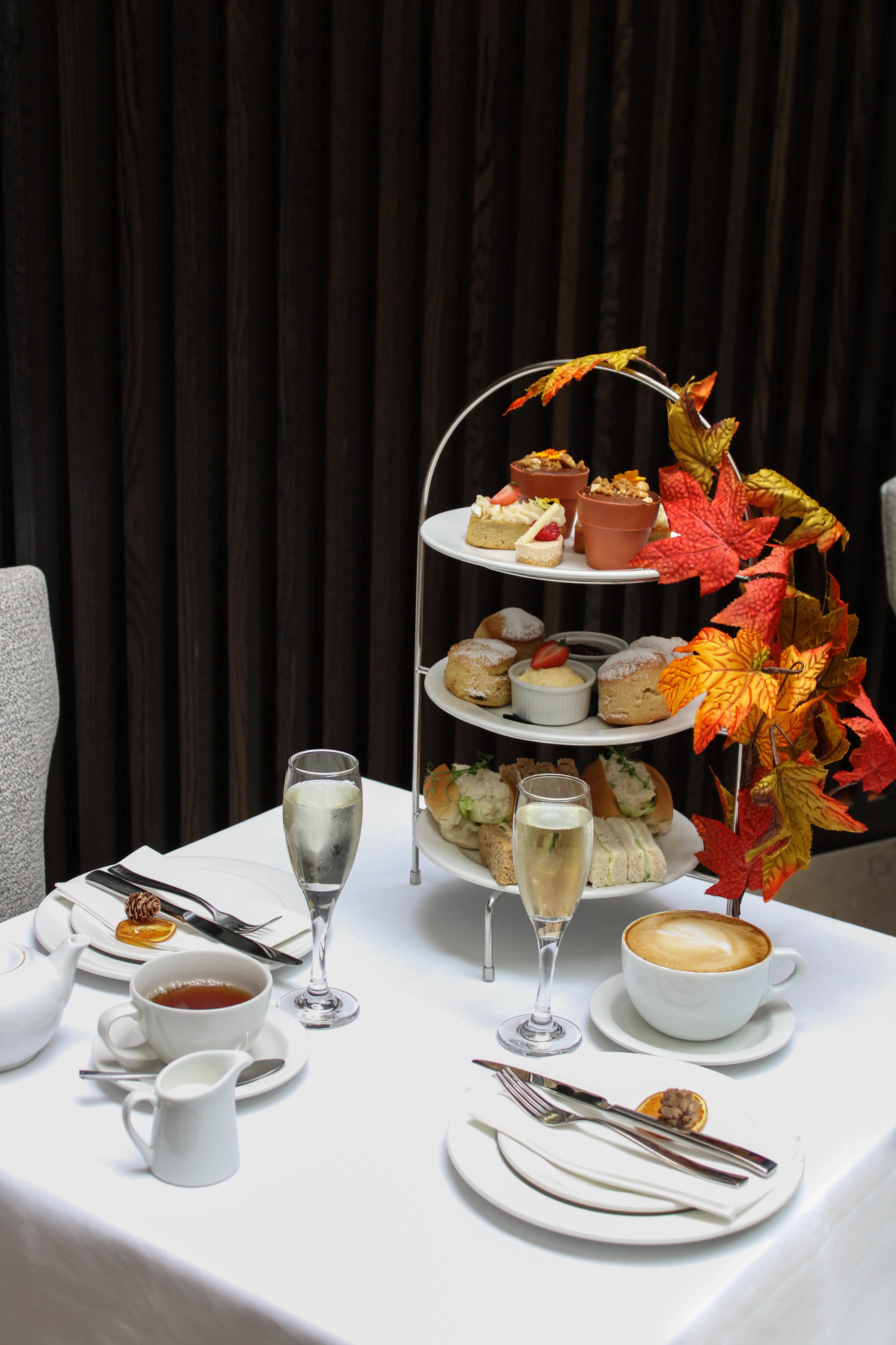 Full autumn afternoon tea spread with scones, sandwiches, and seasonal treats