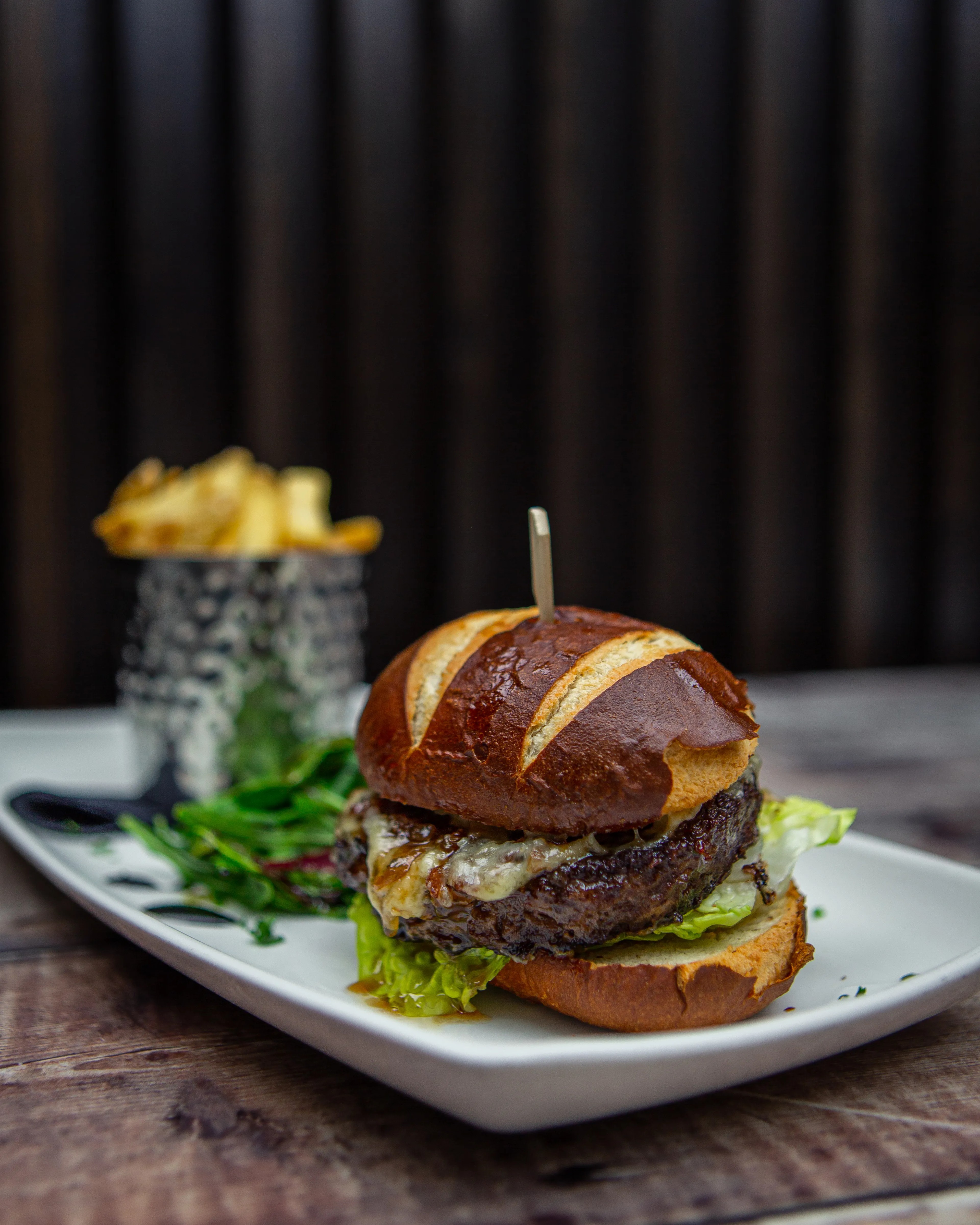 Gourmet burger with brioche bun and hand-cut chips at The Brasserie