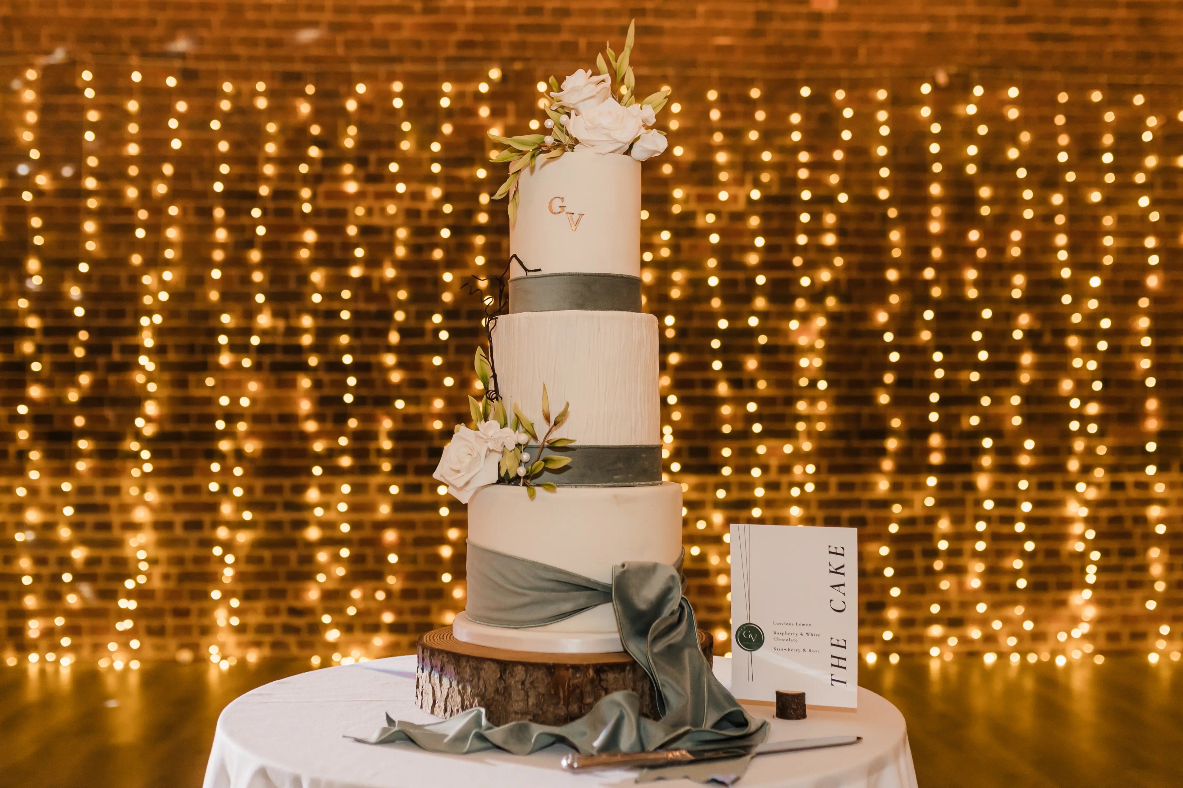 Wedding cake with fairy light backdrop at One Warwick Park