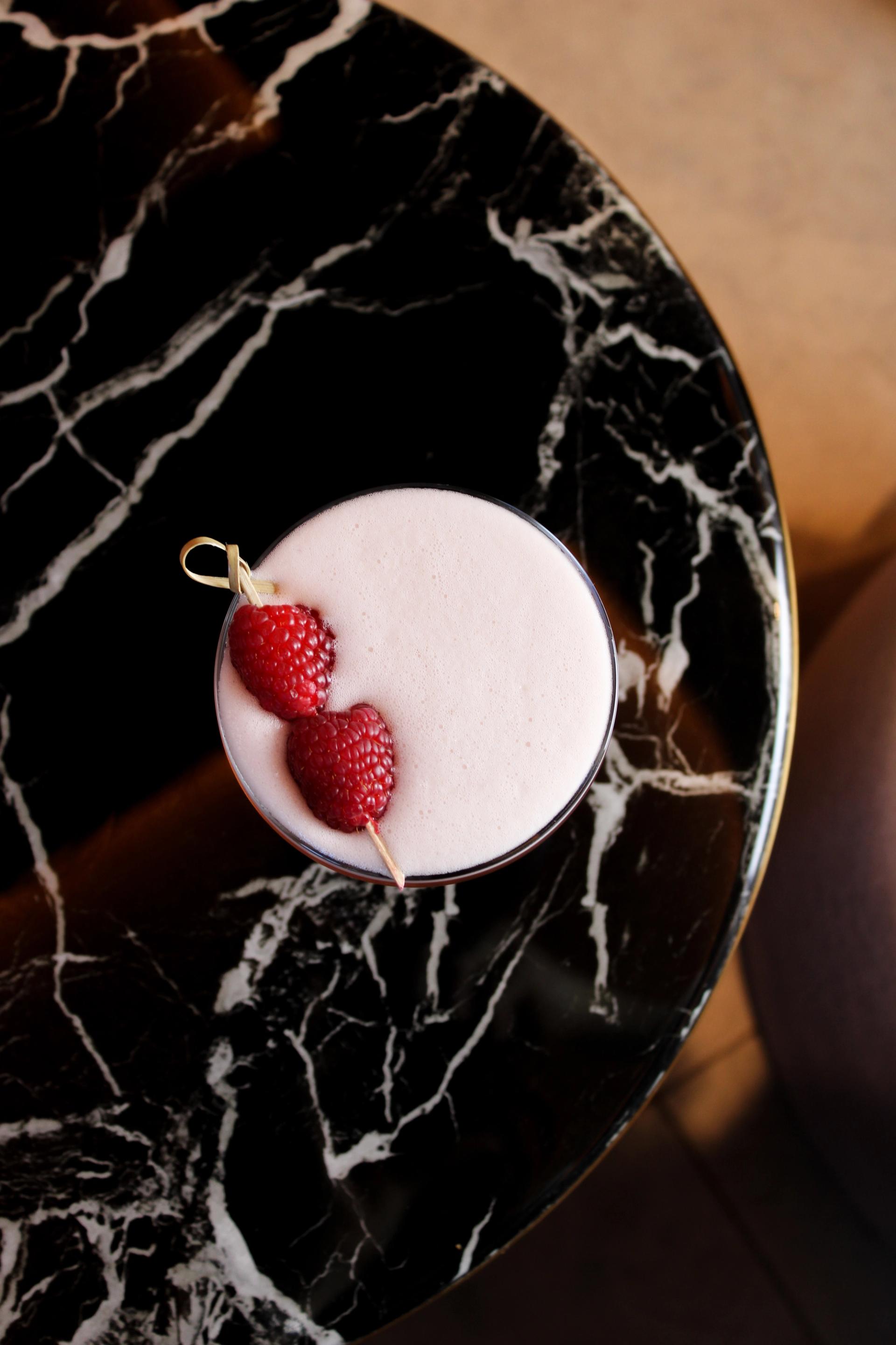 Signature cocktails on velvet seating at The Bar