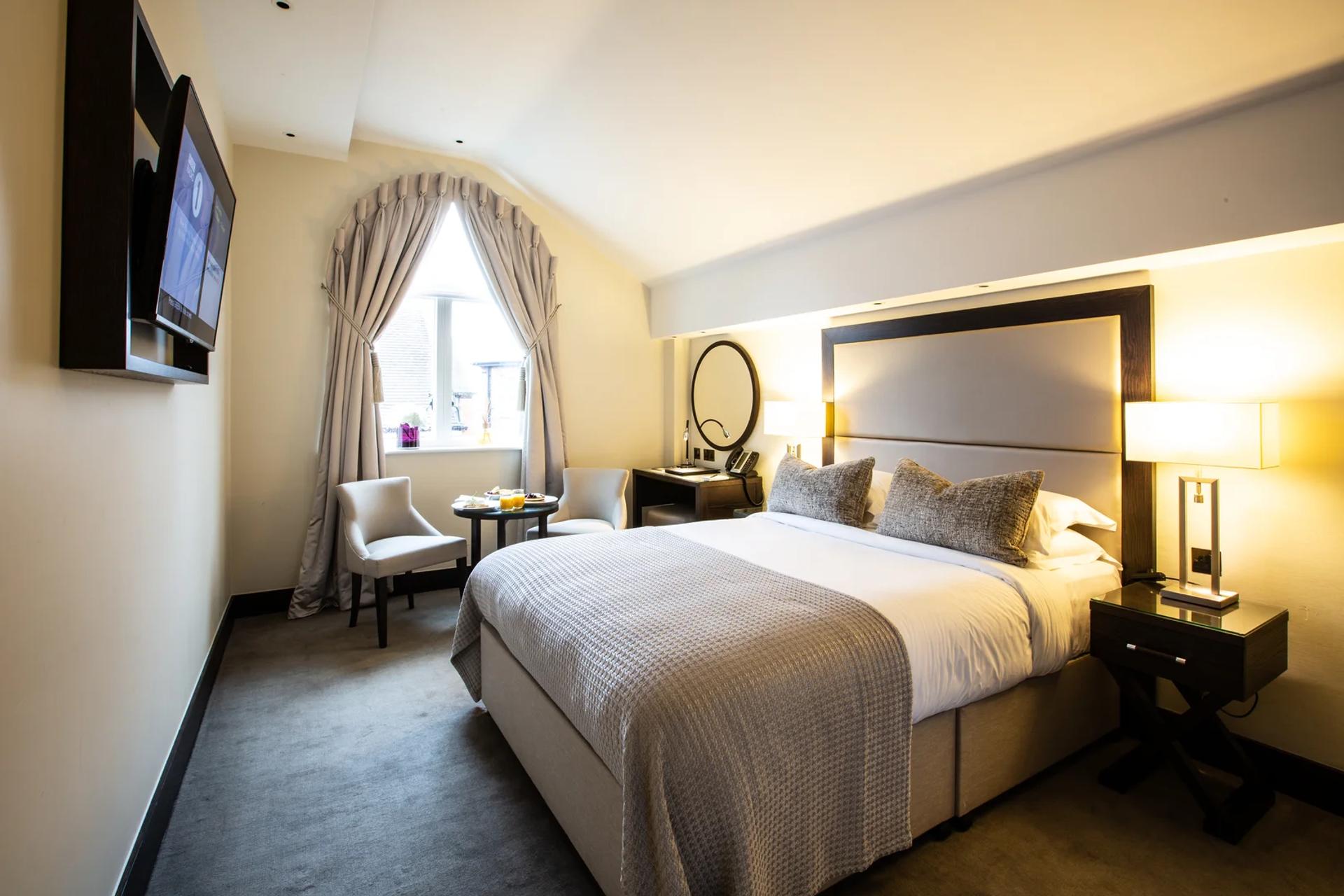 Luxurious Executive Room with king bed, vanity mirror and elegant decor