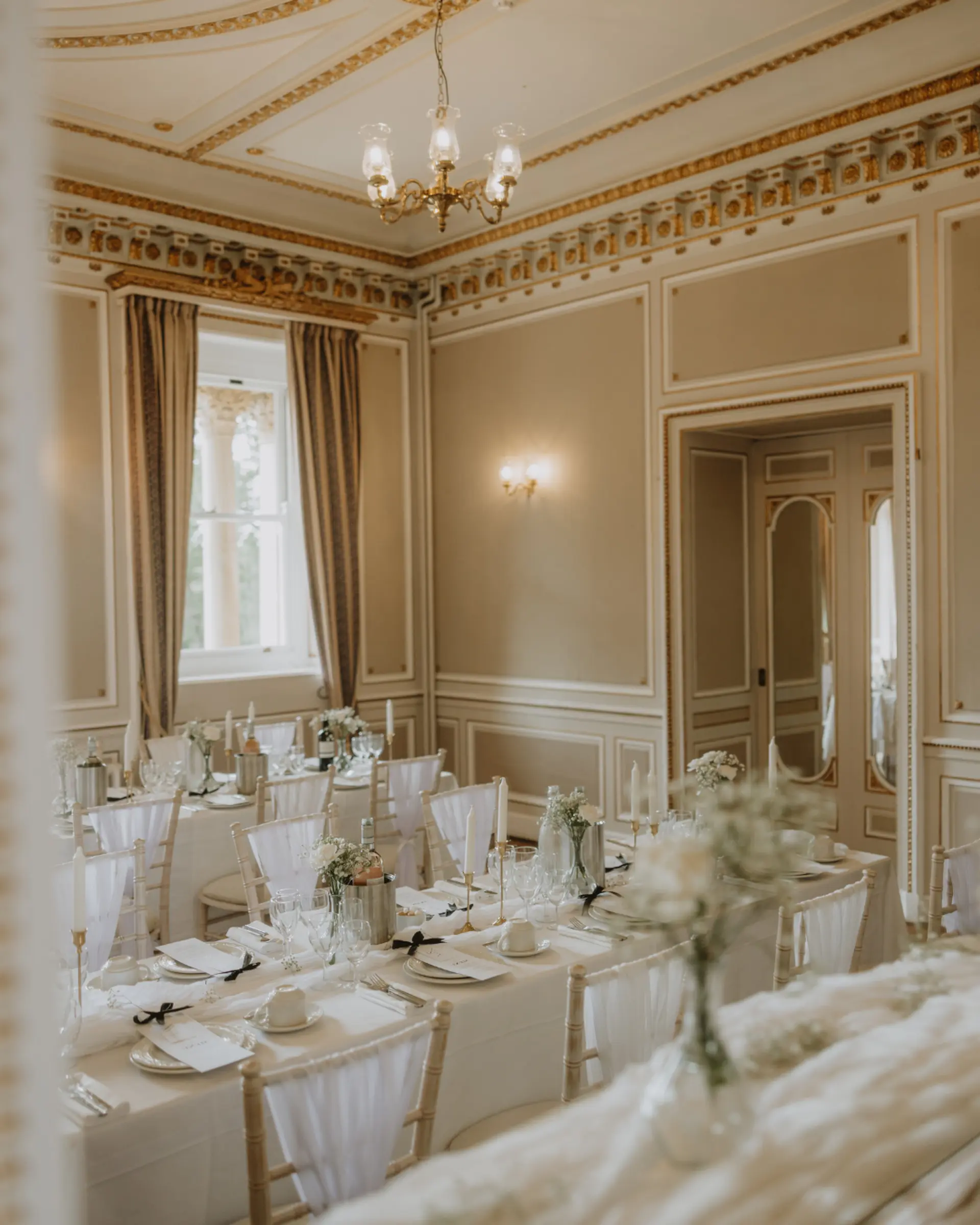 Intimate wedding breakfast in an ornate Victorian room at Salomons Estate