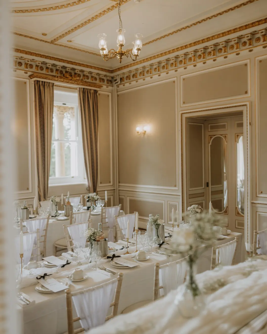 Intimate wedding breakfast in an ornate Victorian room at Salomons Estate
