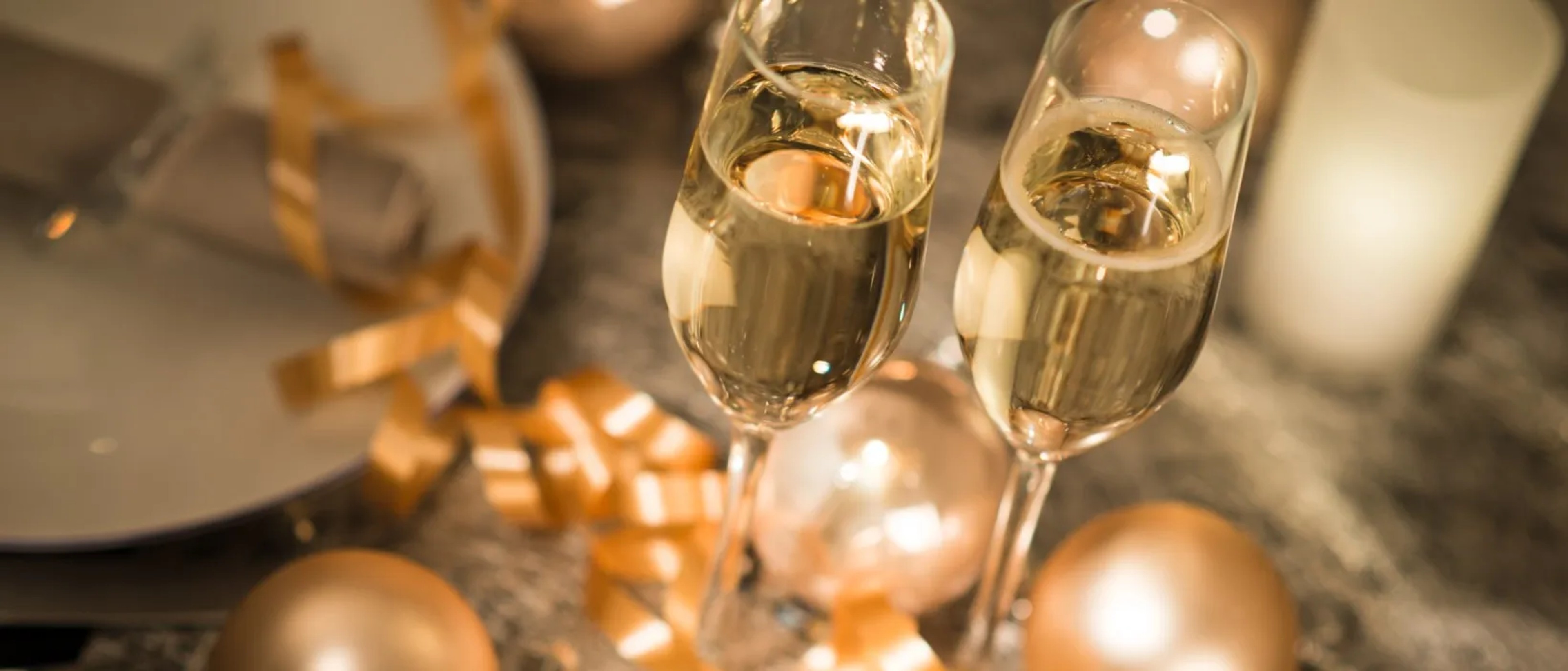 Champagne glasses with gold ribbons for an anniversary celebration