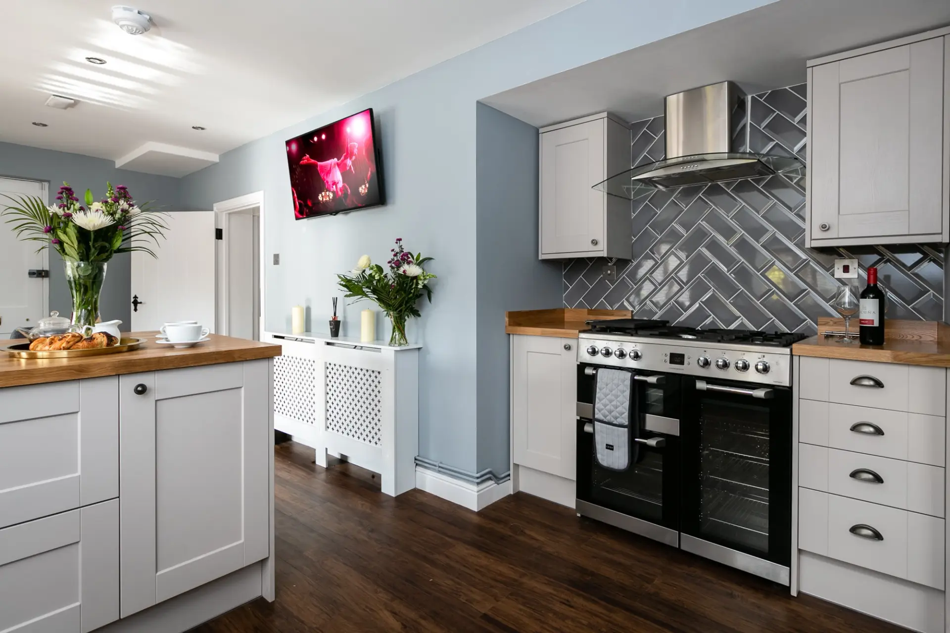 Kitchen with a range cooker and metro tiled splashback at The Cottage, Salomons Estate