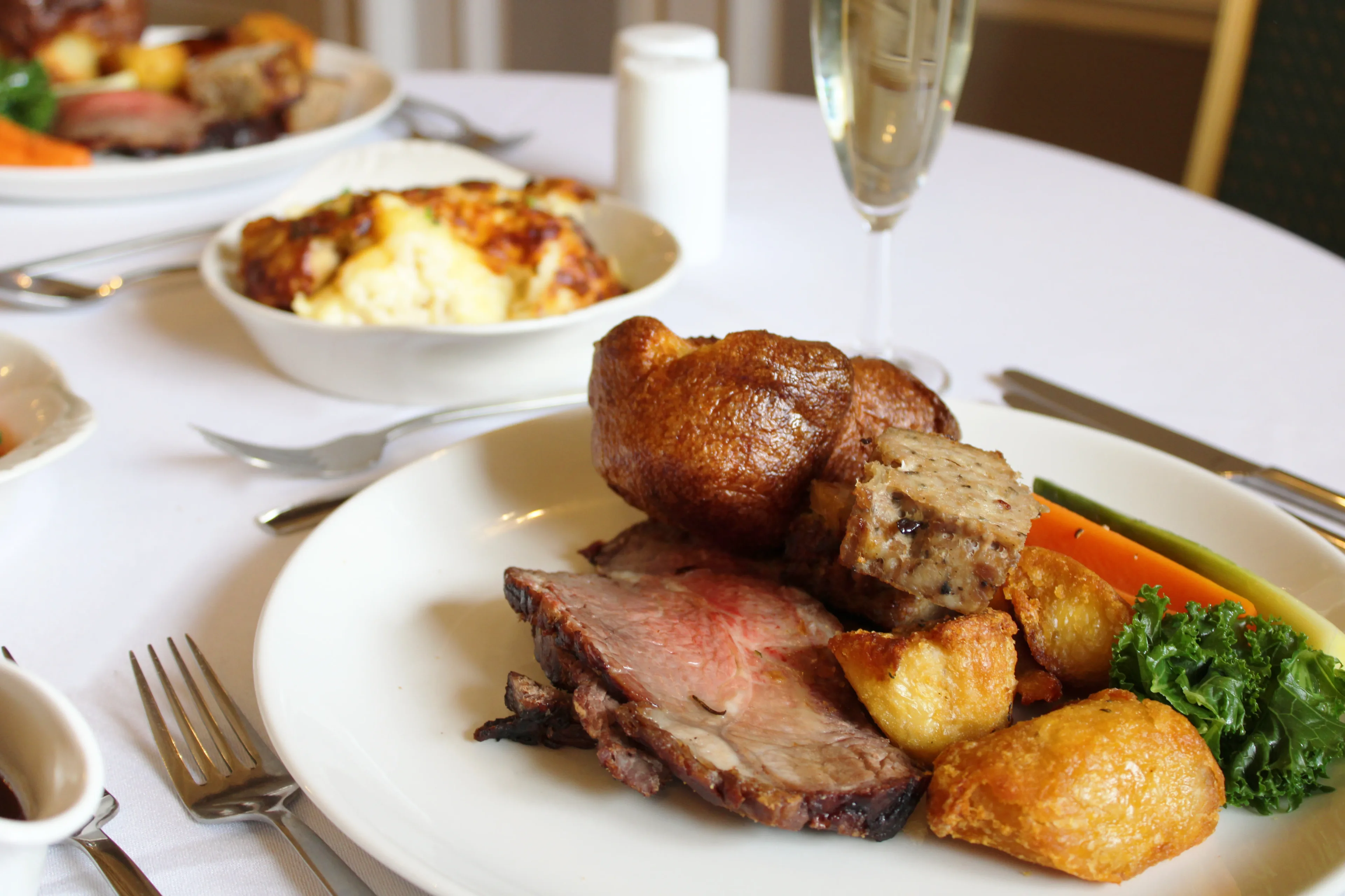Traditional Sunday roast with Yorkshire pudding, roast potatoes, and vegetables at Salomons Estate