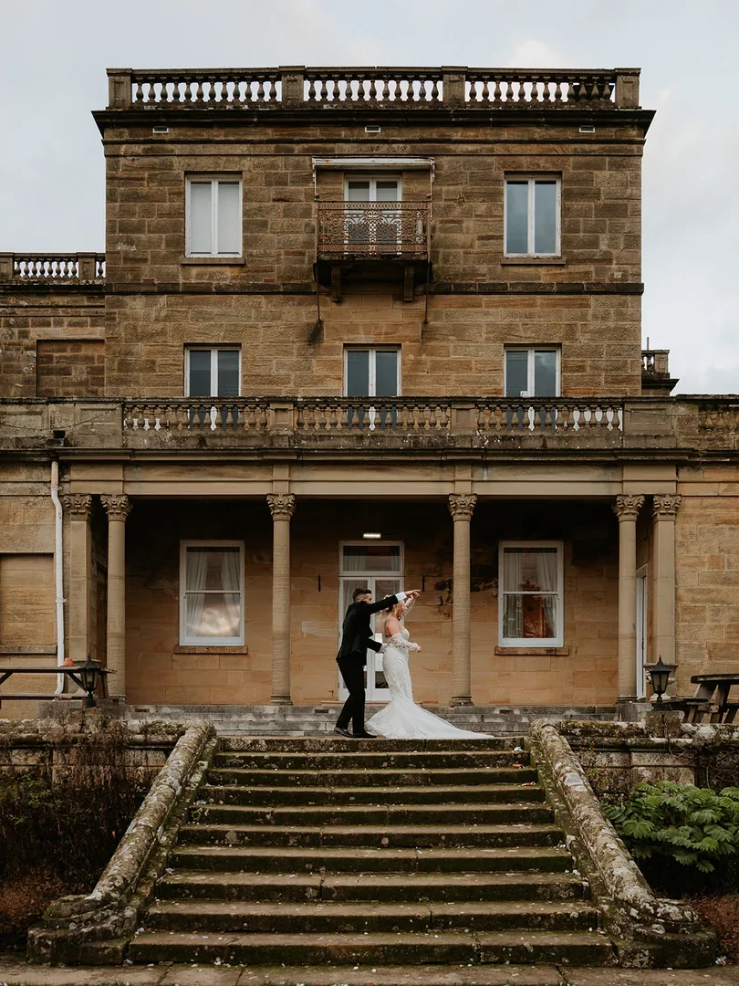Wedding couple portrait on the manor house steps
