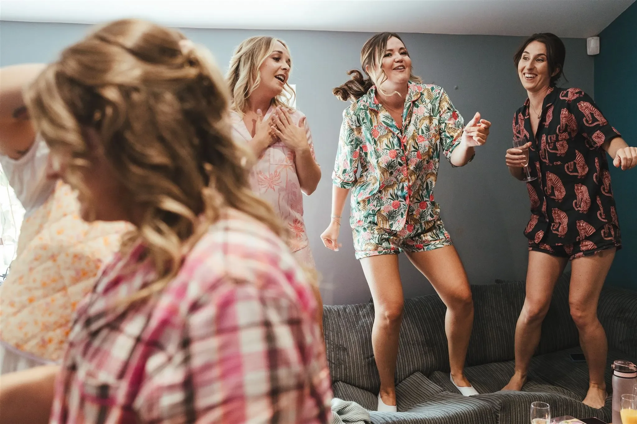 Friends dancing together in matching pyjamas at a hen party at Salomons Estate