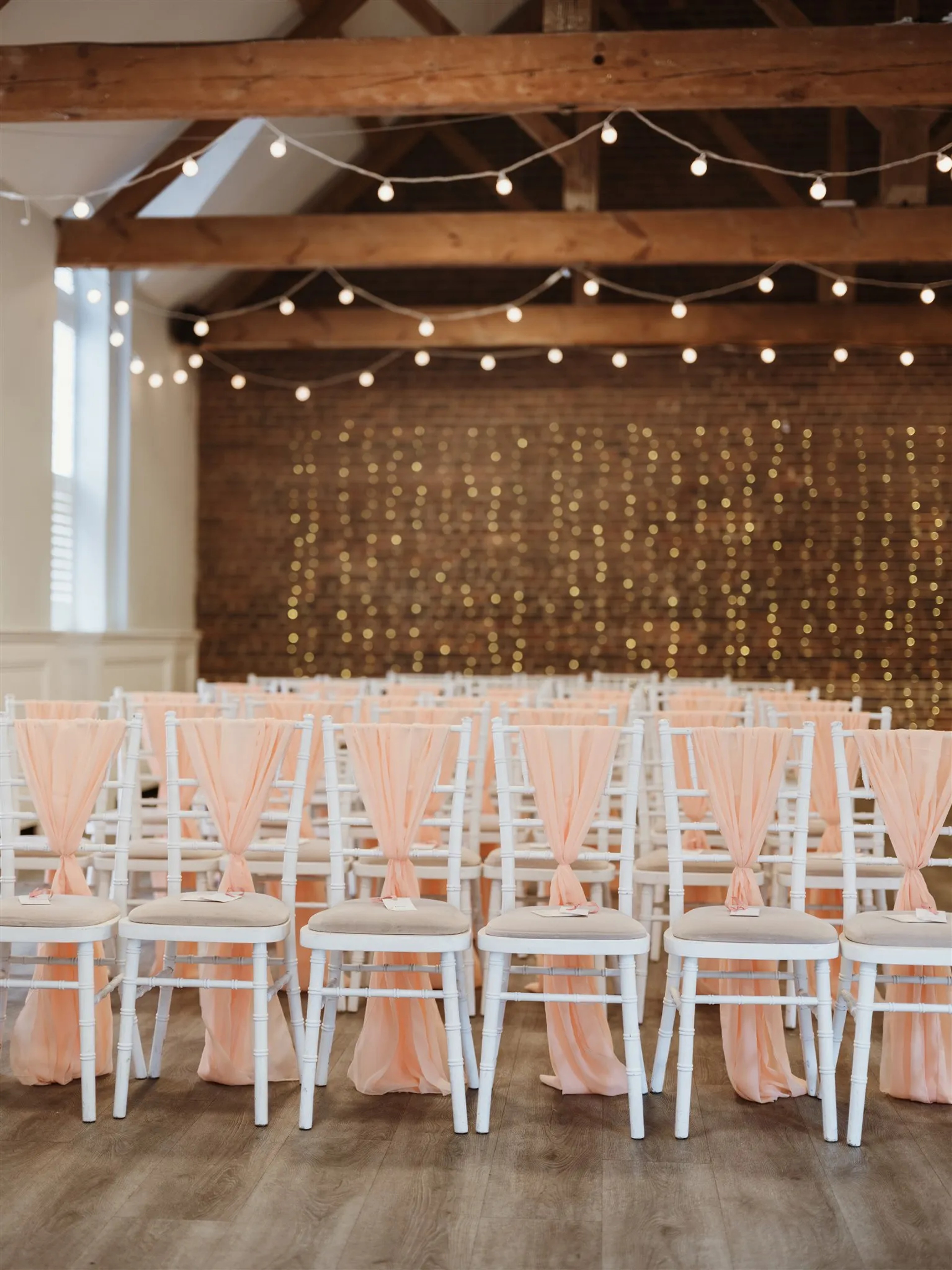 Wedding ceremony room with exposed beams and fairy lights at One Warwick Park
