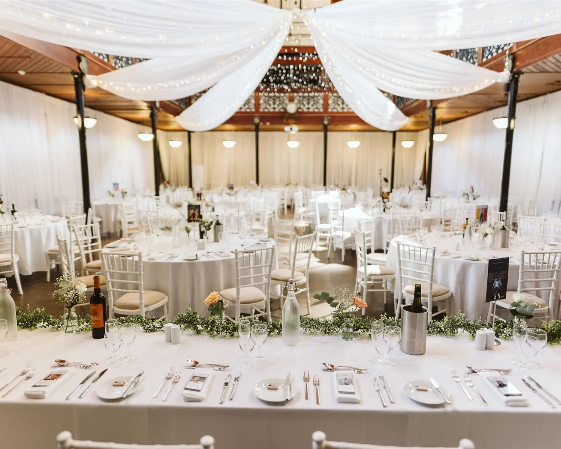 Wide view of a draped wedding reception in the Theatre at Salomons Estate