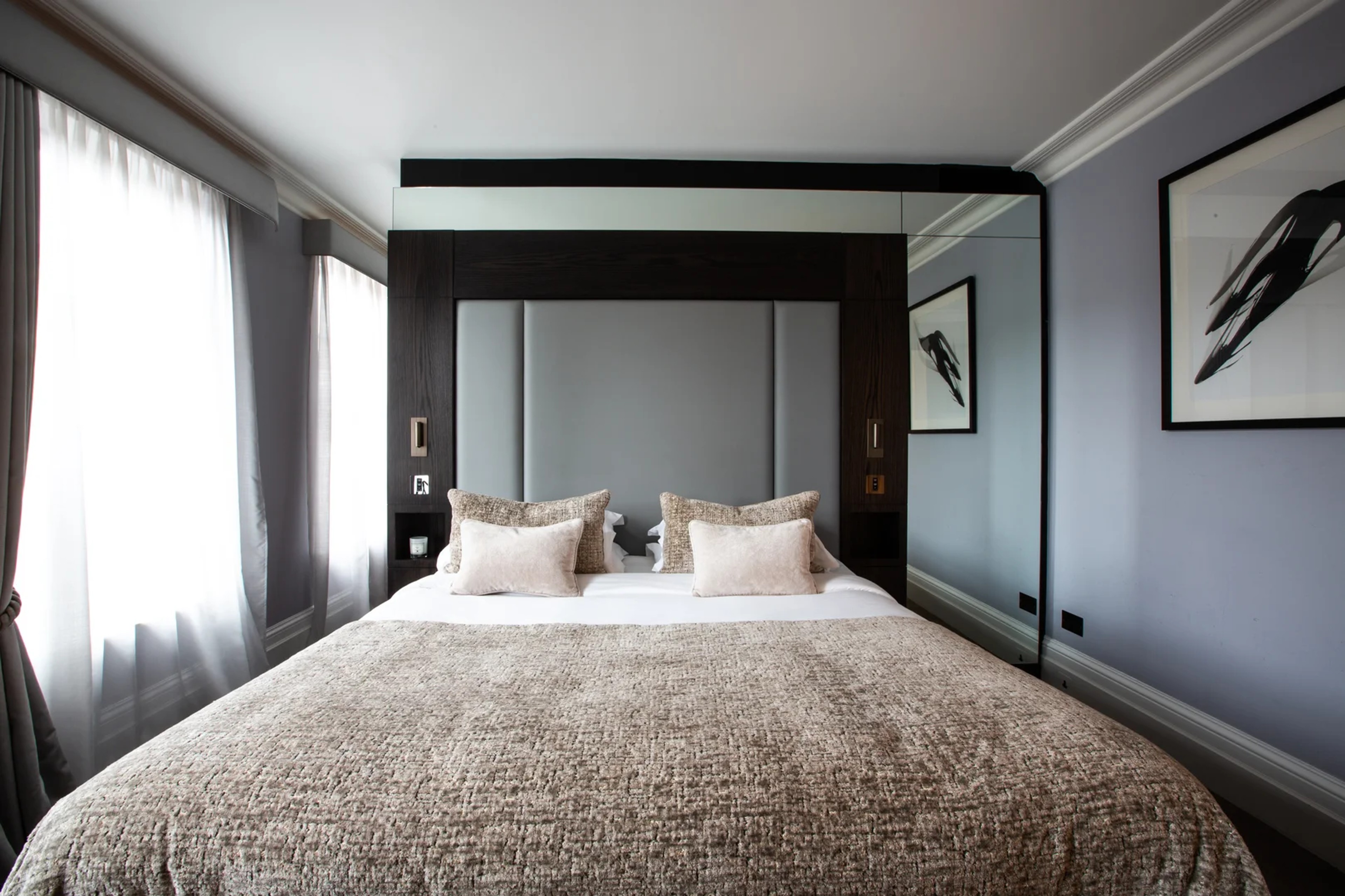 Comfortable king bed in Deluxe Room with elegant decor