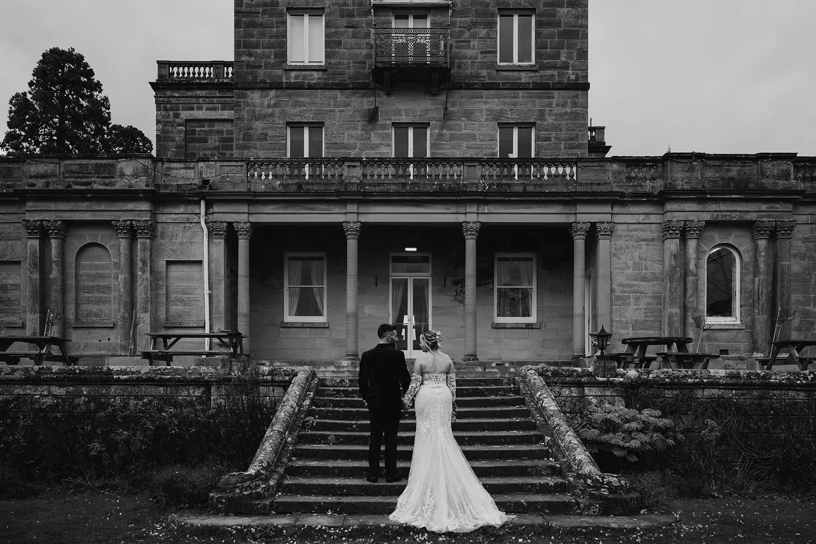 Couple walking towards Salomons Estate manor house in winter