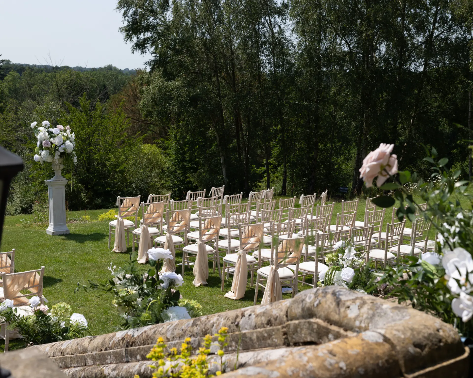Outdoor wedding ceremony seating in the gardens at Salomons Estate