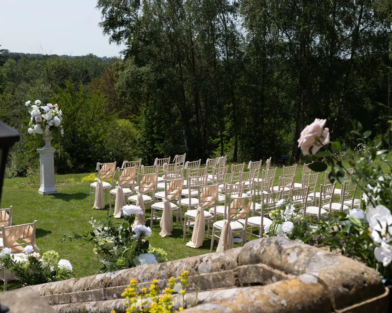 Outdoor wedding ceremony seating in the gardens at Salomons Estate