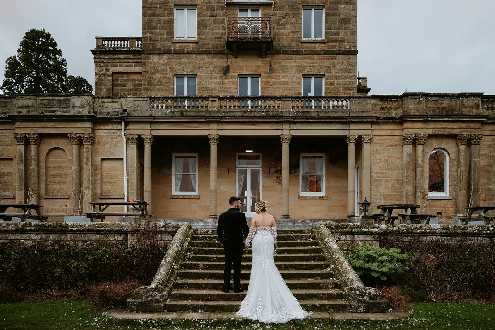 Wedding couple walking through Salomons Estate grounds in winter