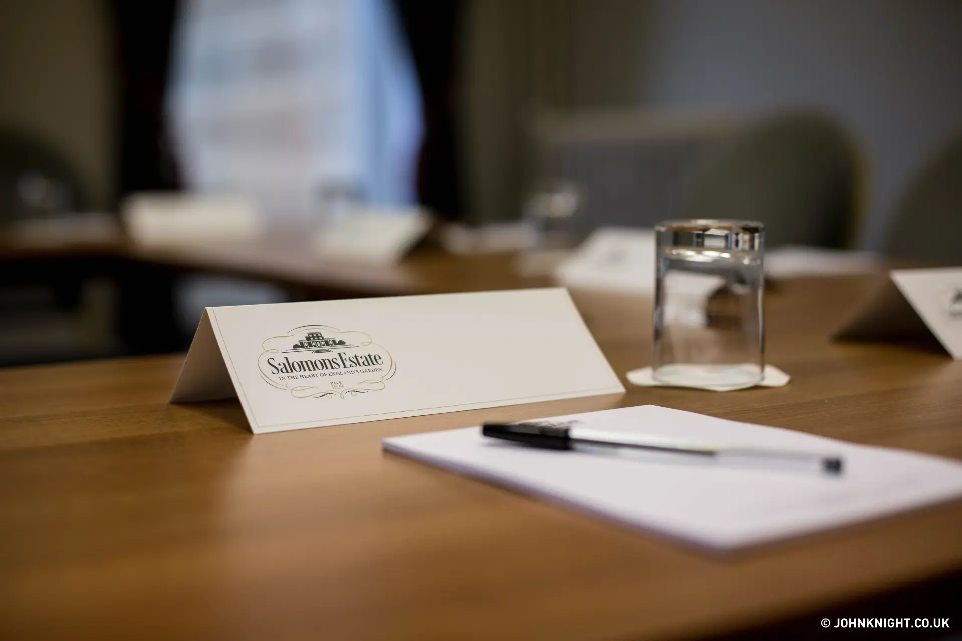Salomons Estate branded place card and notepad on a conference table