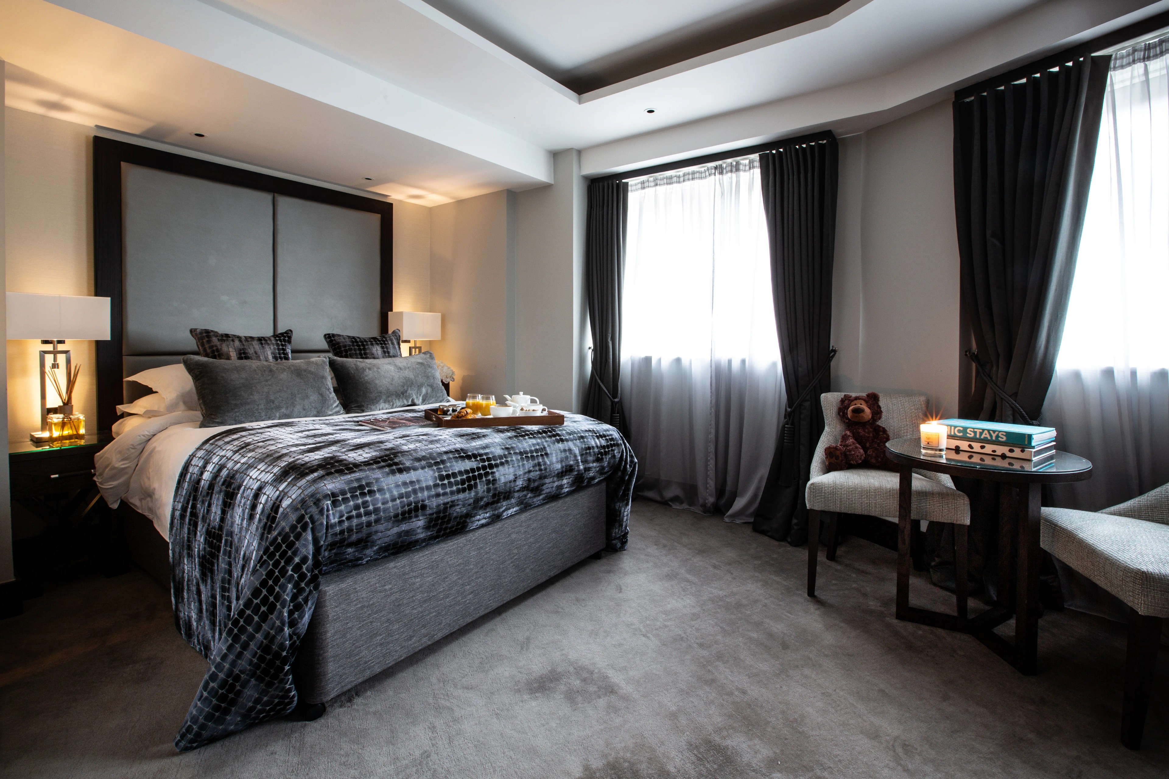 Luxurious Junior Suite with king bed and elegant grey decor at One Warwick Park