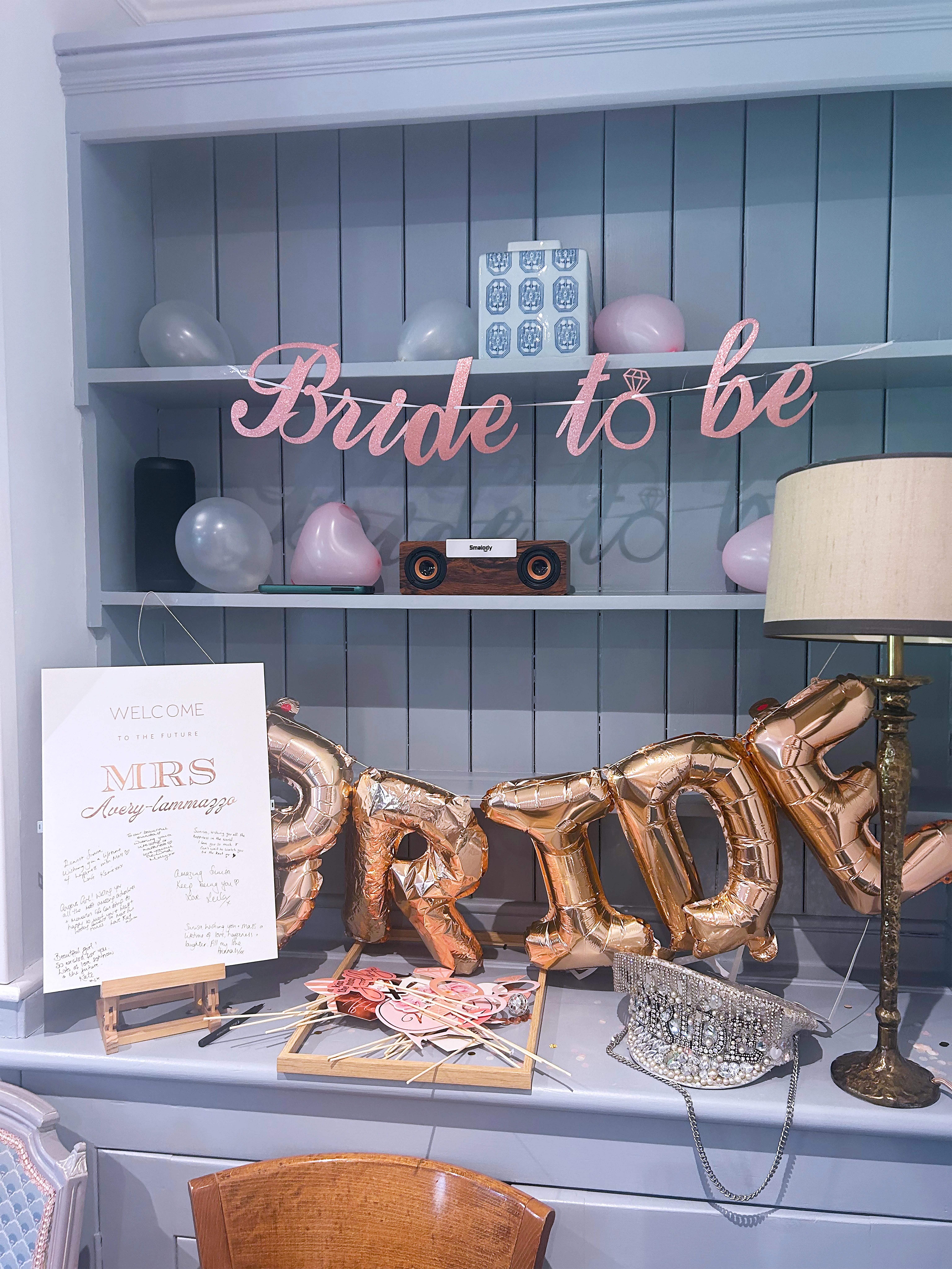 Bride to be decorations with pink balloons, gold letter balloons, and photo props at Salomons Estate