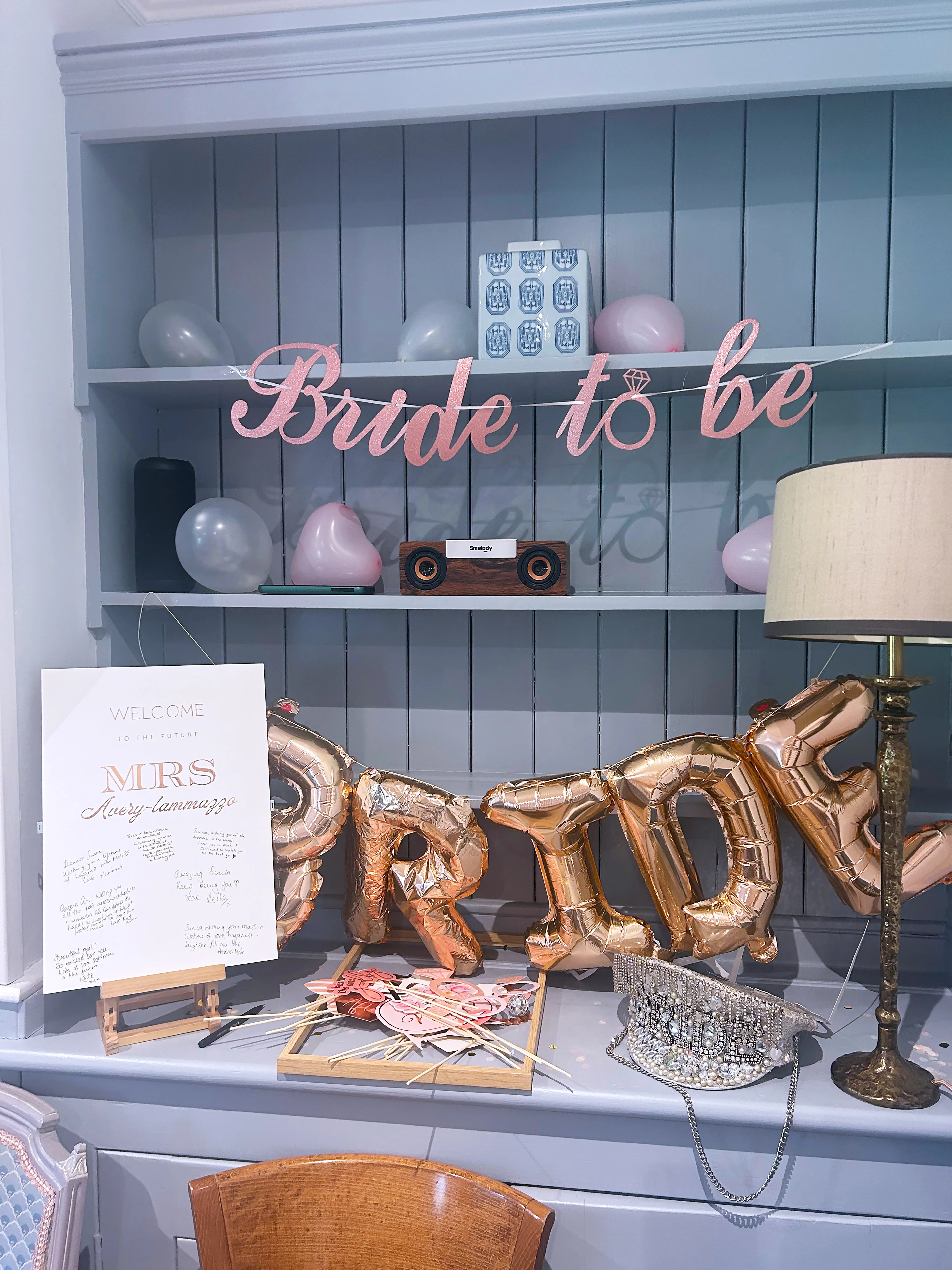 Bride to be decorations with pink balloons, gold letter balloons, and photo props at Salomons Estate
