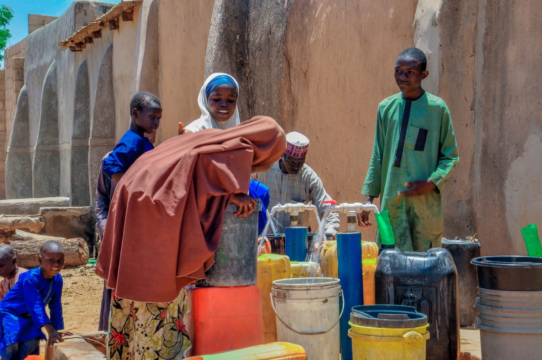 beneficiary enjoying water supply