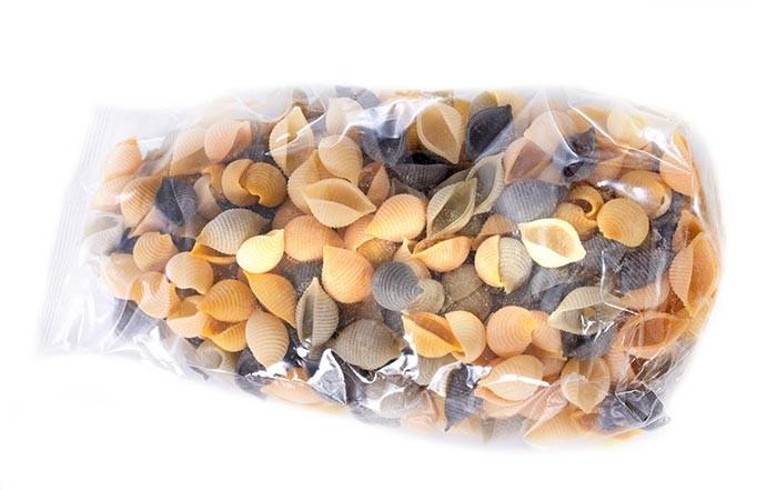 Clear CPP bag of tri-color shell pasta Clear cast polypropylene (CPP) bag of tri-color shell pasta showing high-gloss clarity and sealed edge.