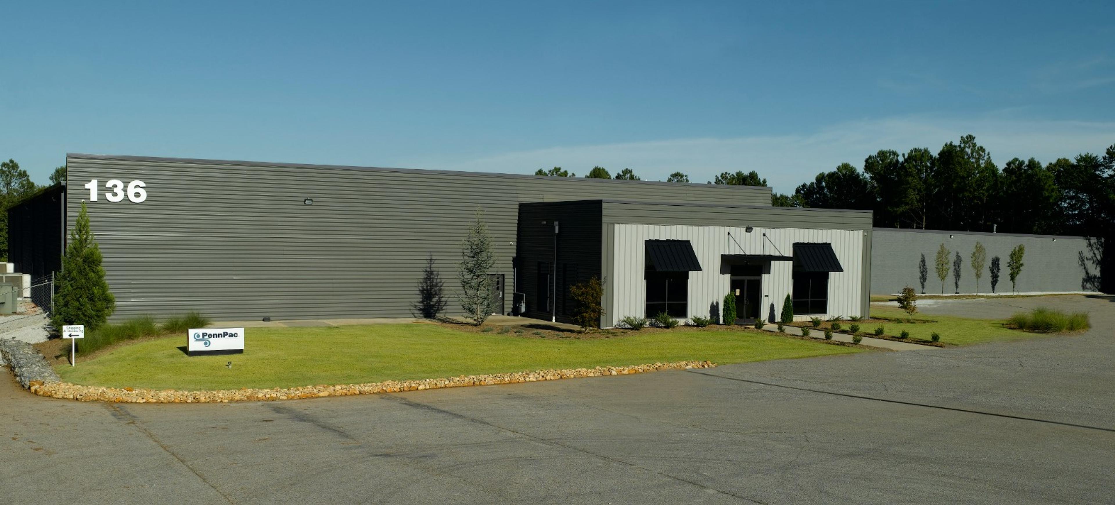 Exterior of PennPac's Piedmont, SC facility at 136 Leader Drive, a gray metal warehouse with a PennPac sign on the front lawn.