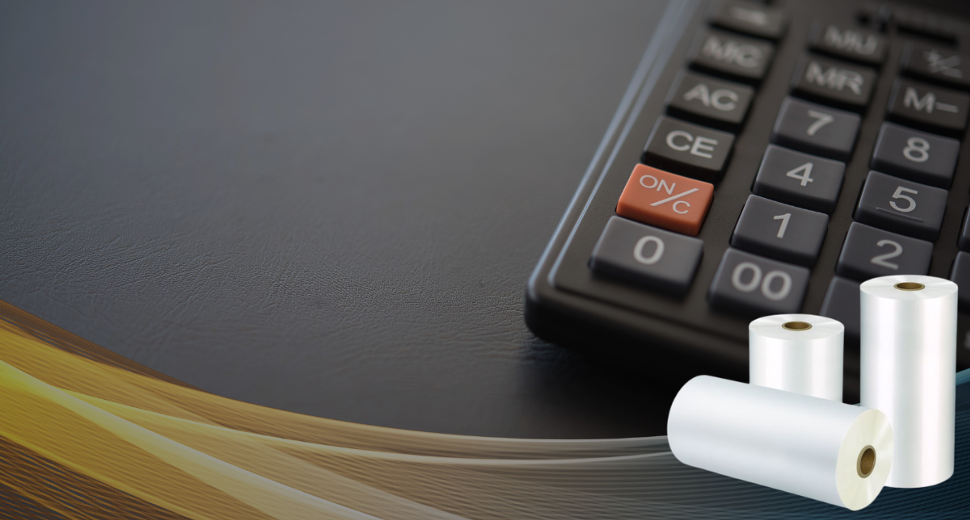 Calculator keypad and three white flexible packaging film rolls on a dark textured surface with a gold accent wave