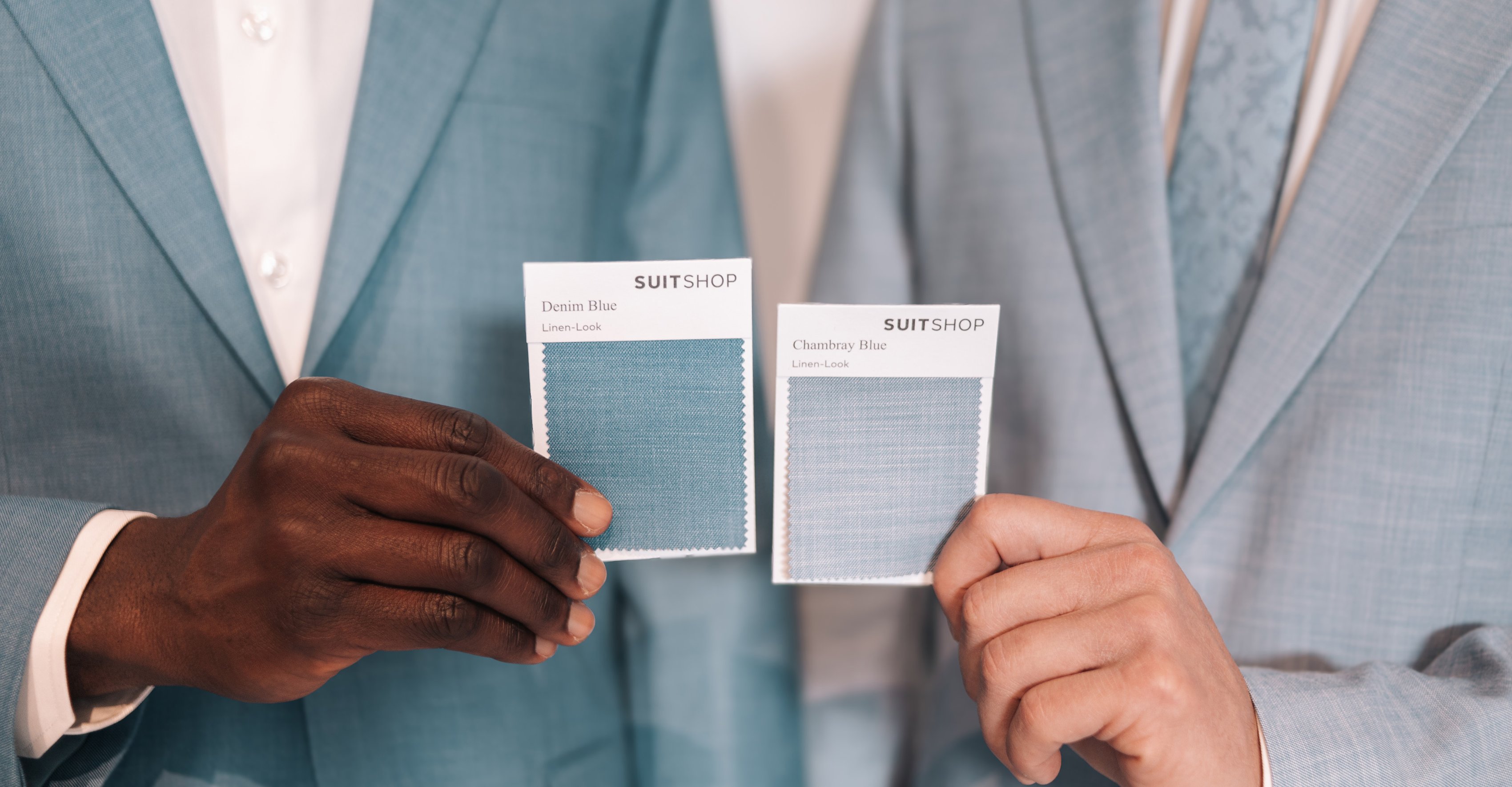 Two people in Linen-Look suits holding up matching fabric swatches in Denim Blue and Chambray Blue.