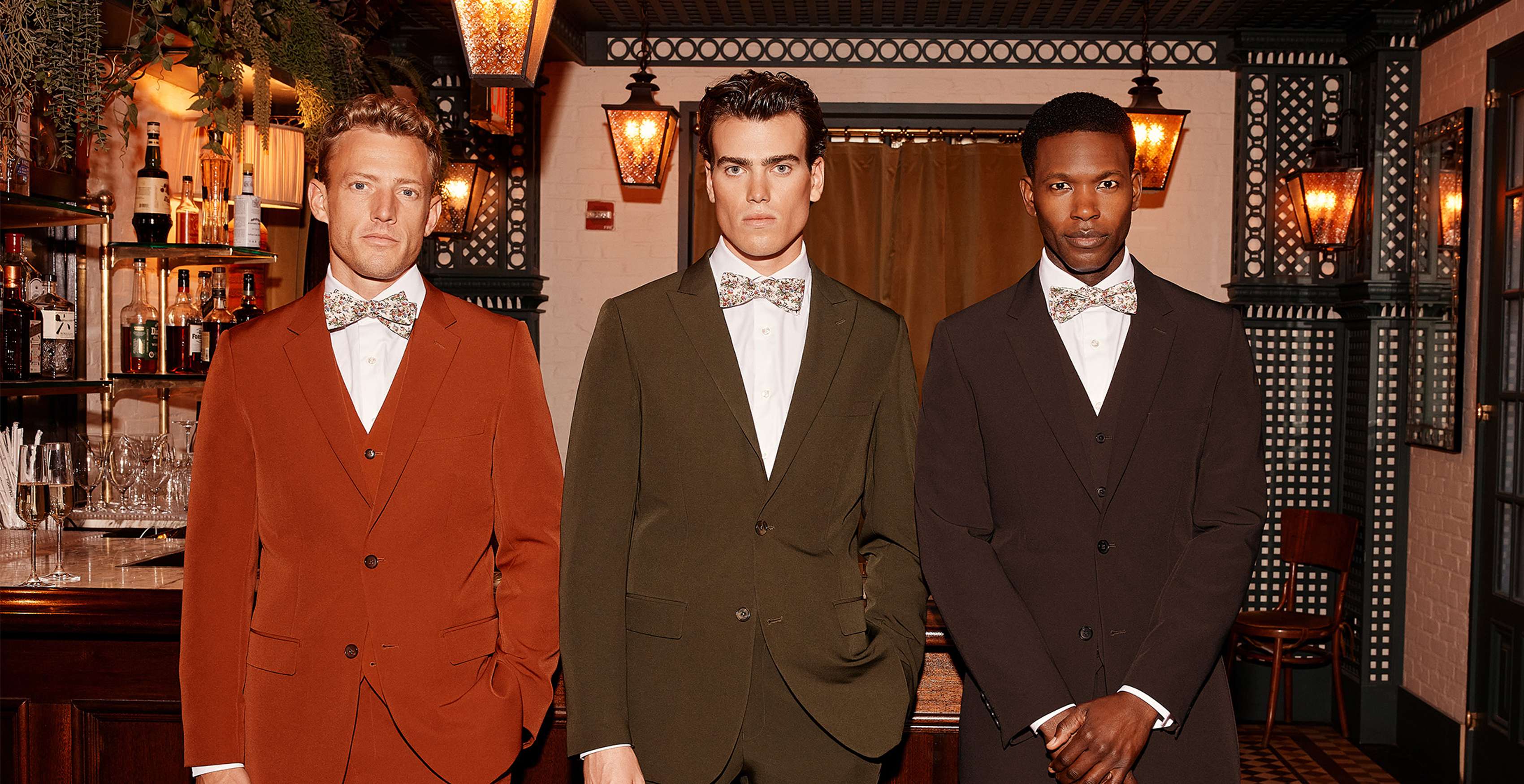 Three gentlemen in suits with rich colors, burnt orange, olive green, and deep brown