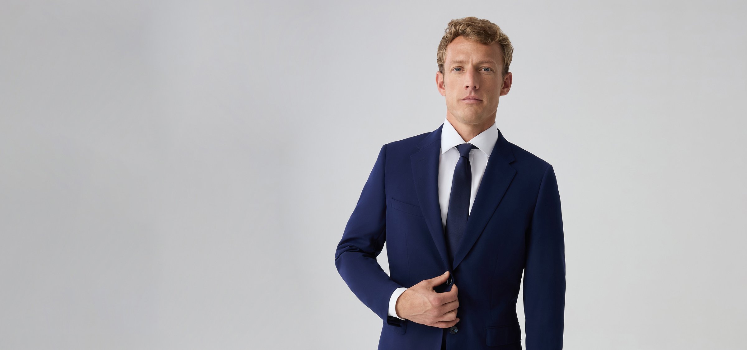 Well-dressed man wearing a slim fit royal blue suit