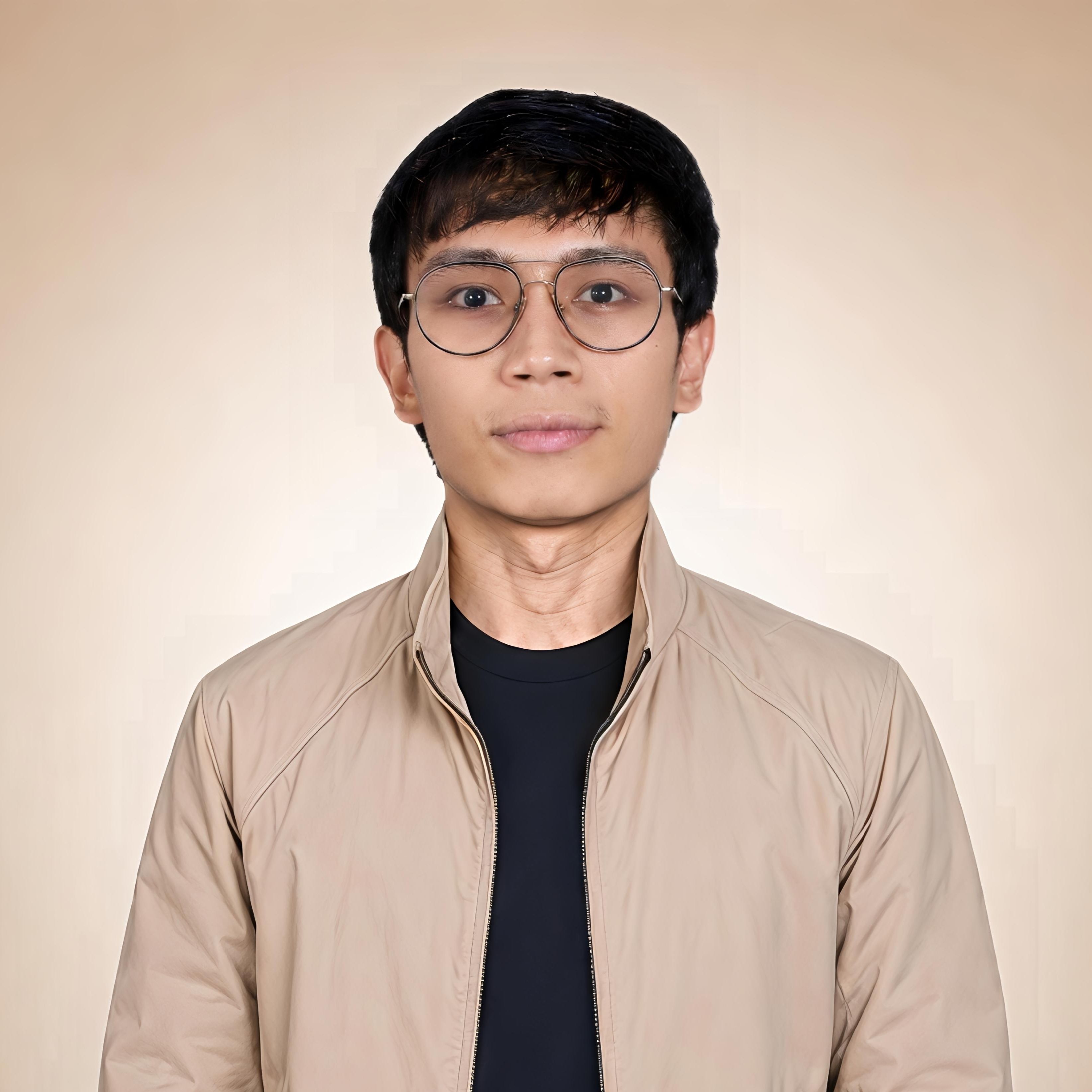 Portrait of Elloani Ross Pitogo, wearing beige jacket, dark inner shirt, and eyeglasses.