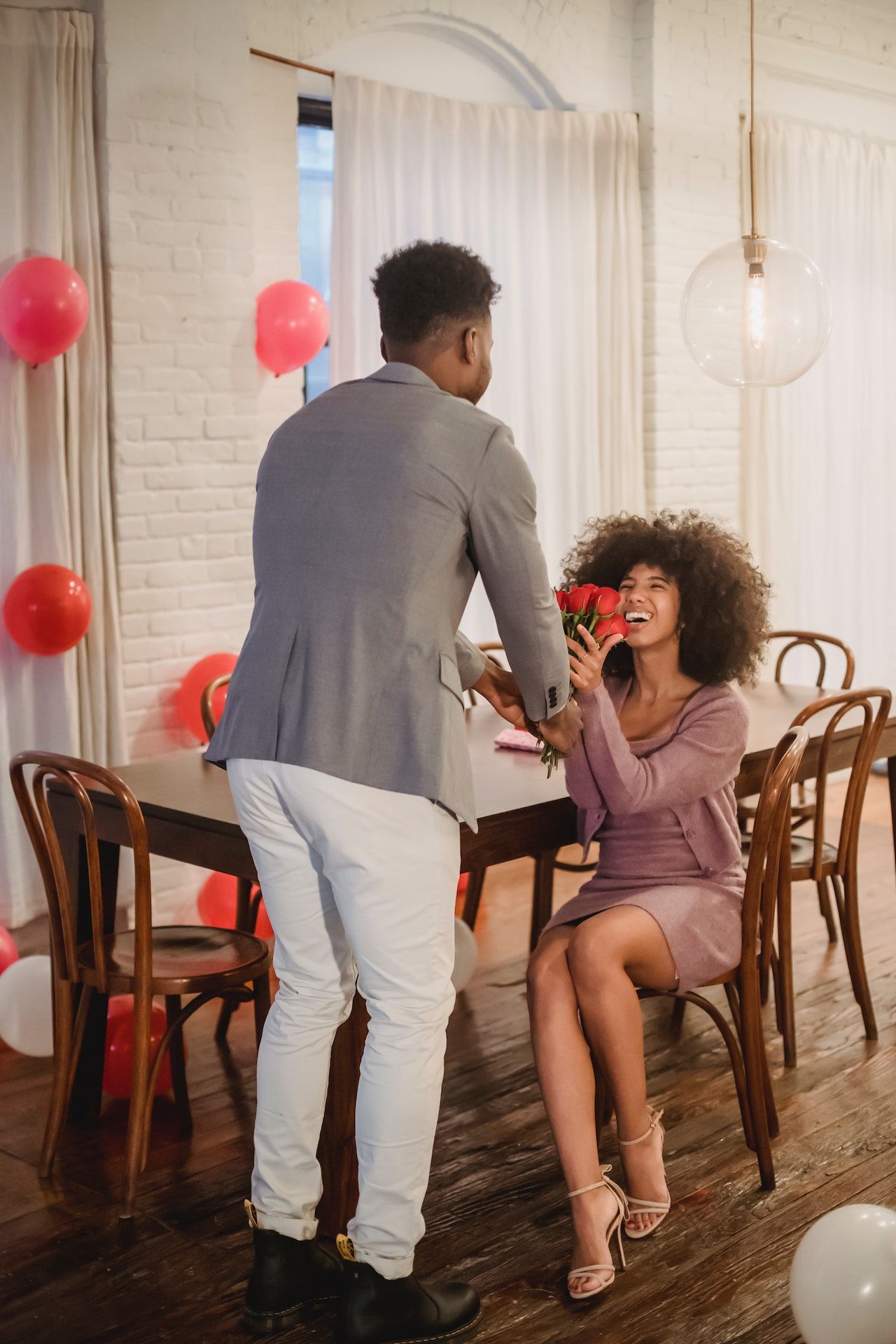 A picture of a man giving a woman flowers