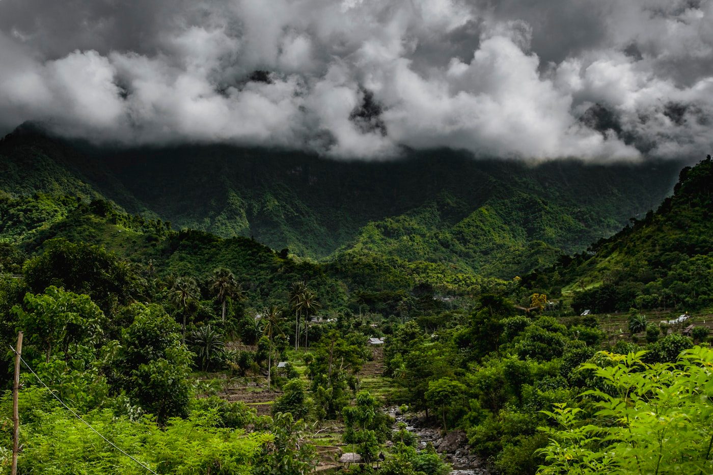 A green mountain landscape beneath cloud cover
