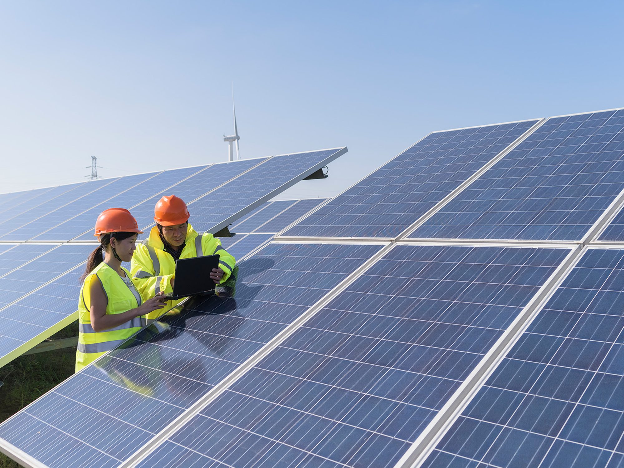 Young asian engineers working in a solar power station
