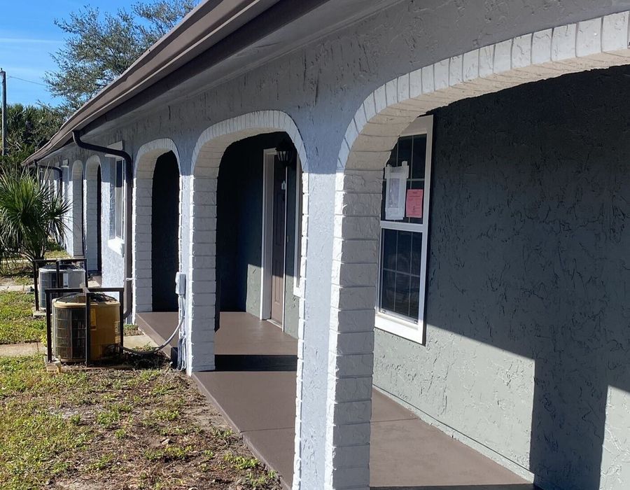 Exterior painting project in Orlando, FL featuring refreshed arches, updated trims, and revitalized community building exteriors.