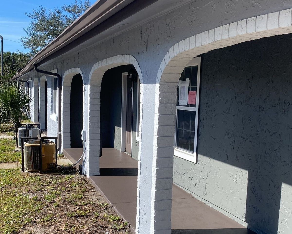 Exterior painting project in Orlando, FL featuring refreshed arches, updated trims, and revitalized community building exteriors.