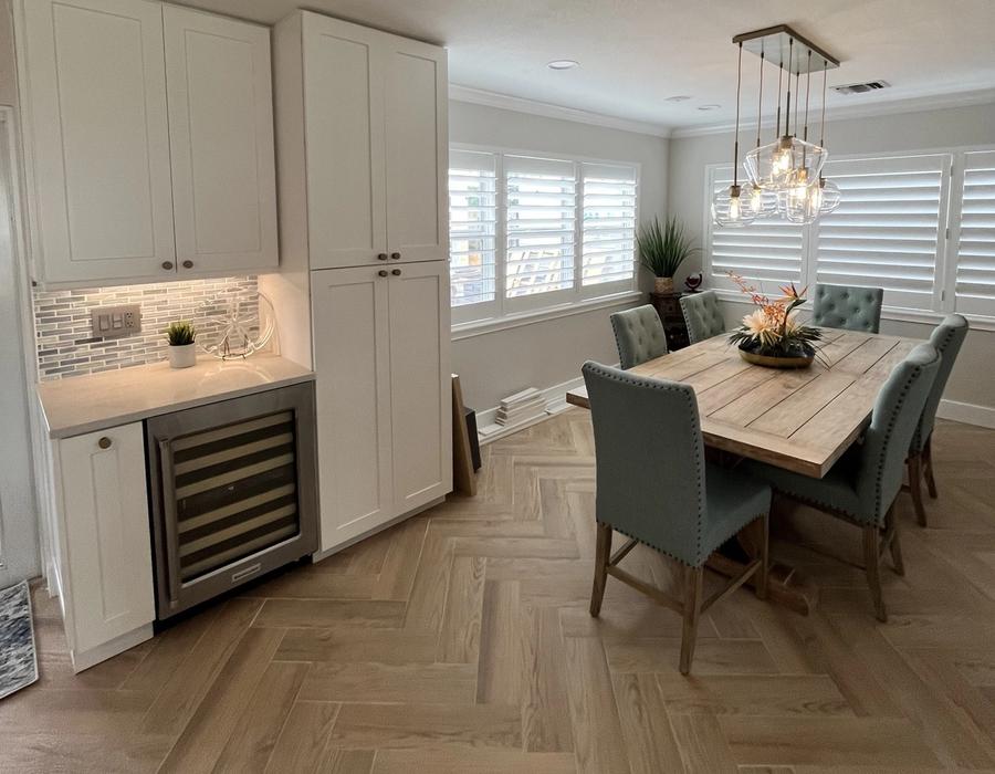Dining area with custom cabinetry and built-in wine cooler from a Deerfield Beach, FL kitchen remodel, featuring elegant finishes and modern design.