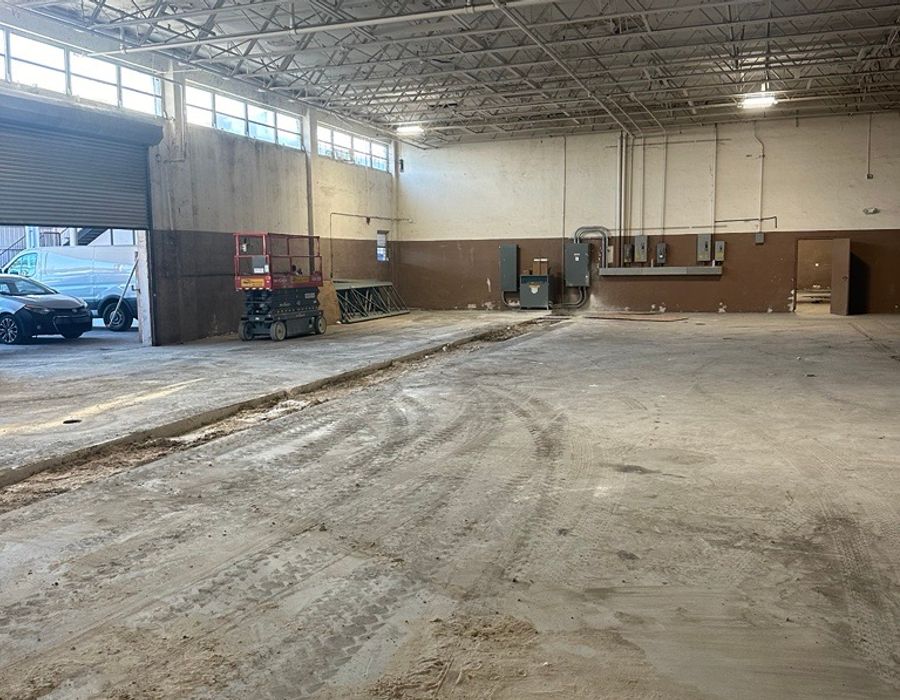 Warehouse concrete restoration in Opa-locka, FL with trenching, pipe replacement, soil compaction, and 4000 PSI concrete installation.