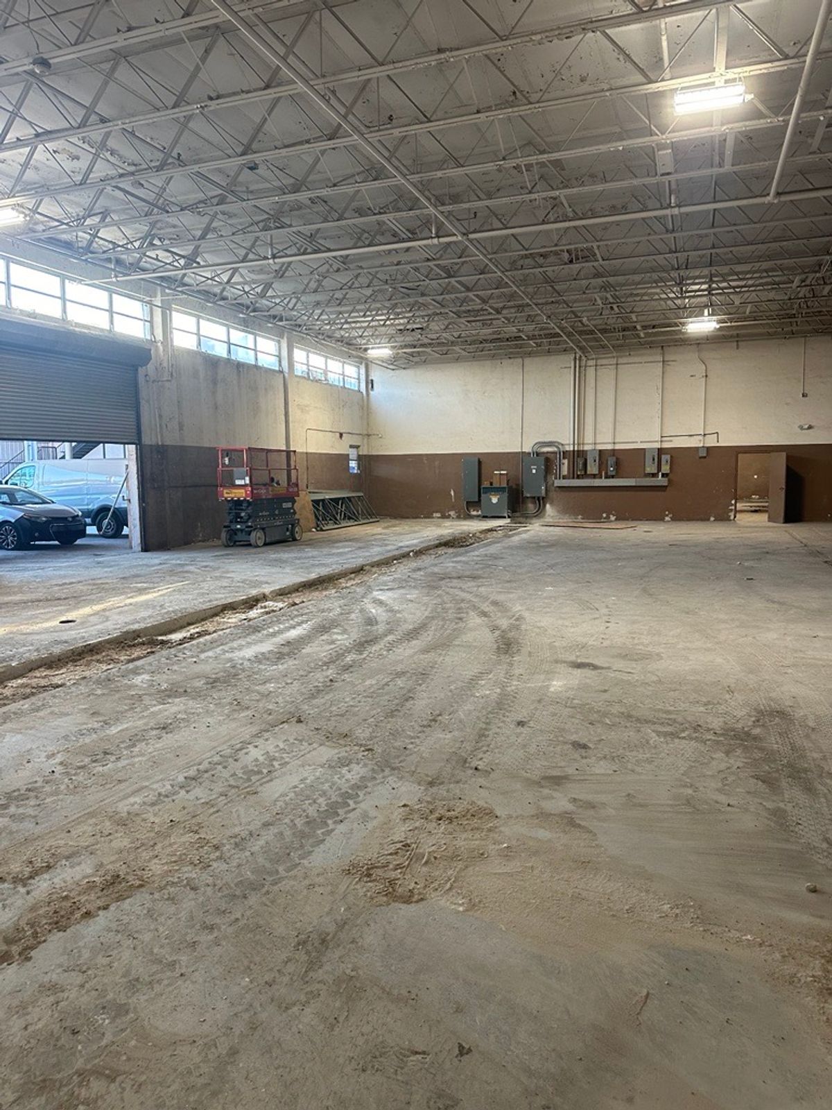 Warehouse concrete restoration in Opa-locka, FL with trenching, pipe replacement, soil compaction, and 4000 PSI concrete installation.